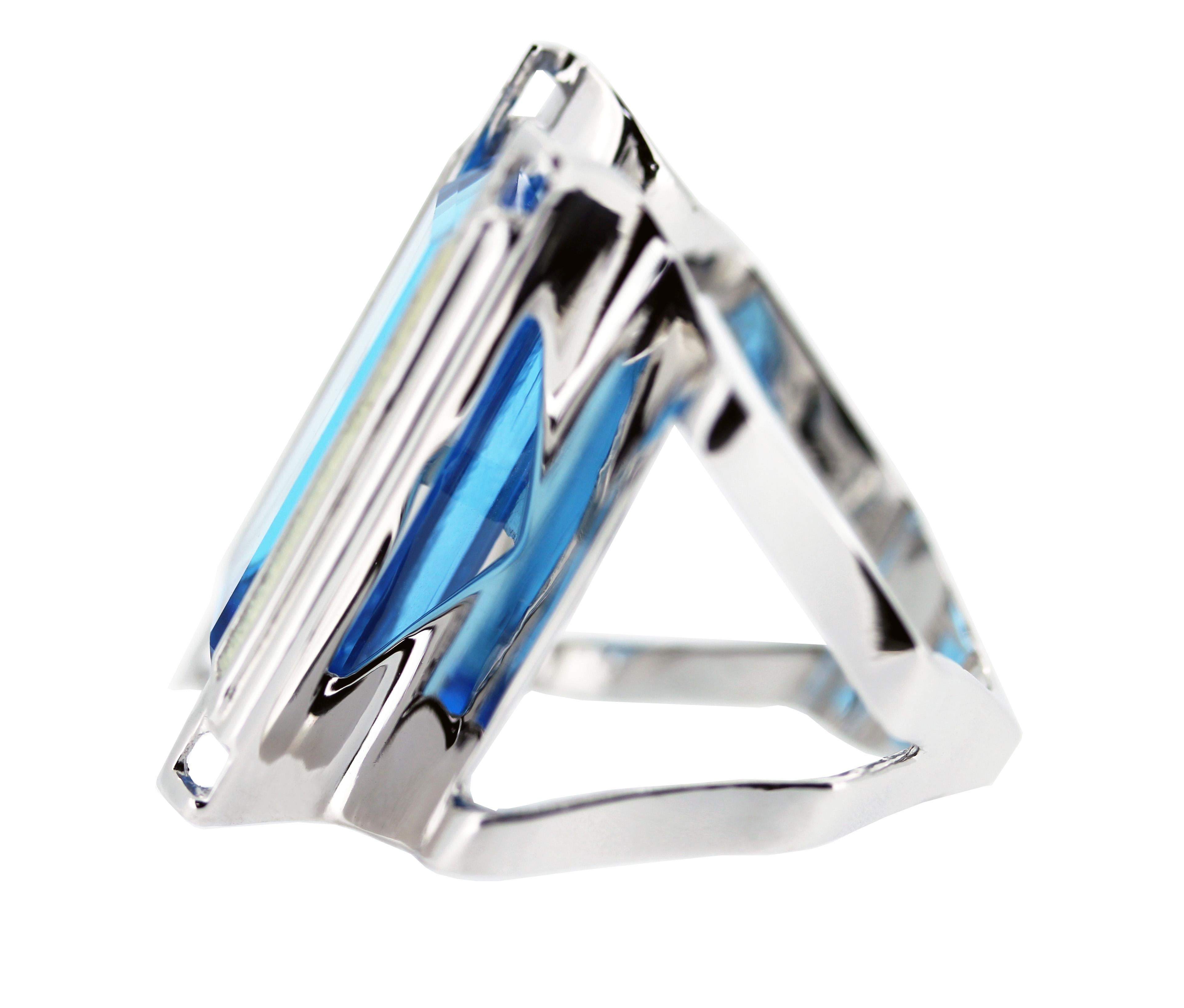 This modern handmade British-London Hallmarked 18 karat white gold ring, set with 23.99 carat electric Swiss blue topaz is from MAIKO NAGAYAMA's Haute Couture Collection called 