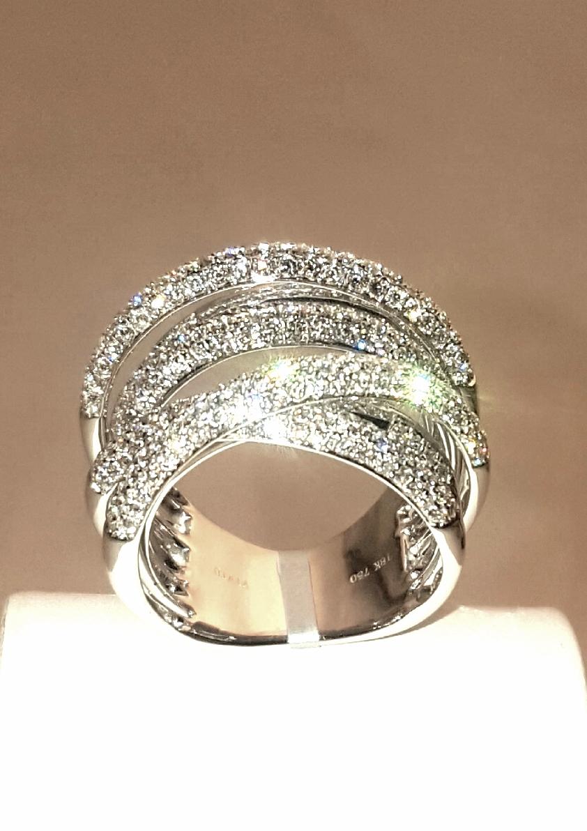 Never worn.  Brand new!  Artfully fabricated in 18 karat white gold this ring is an absolute stunner!  Seven rows encrusted in micro pave white diamonds are gracefully arched at different levels.  Center row goes straight across while each end of