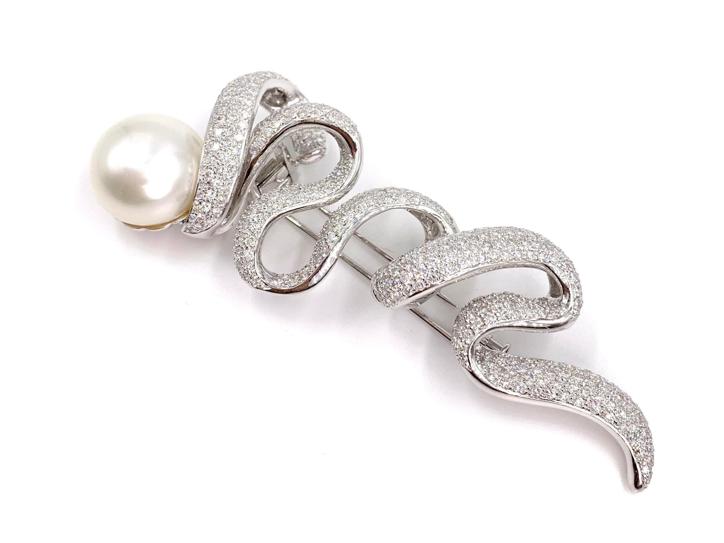 A fabulous, uniquely designed large brooch featuring a genuine white 17.3mm south sea pearl and white diamonds with a generous amount of sparkle. 6.89 carats of bright white diamonds are expertly pave set in polished 18 karat white gold in a