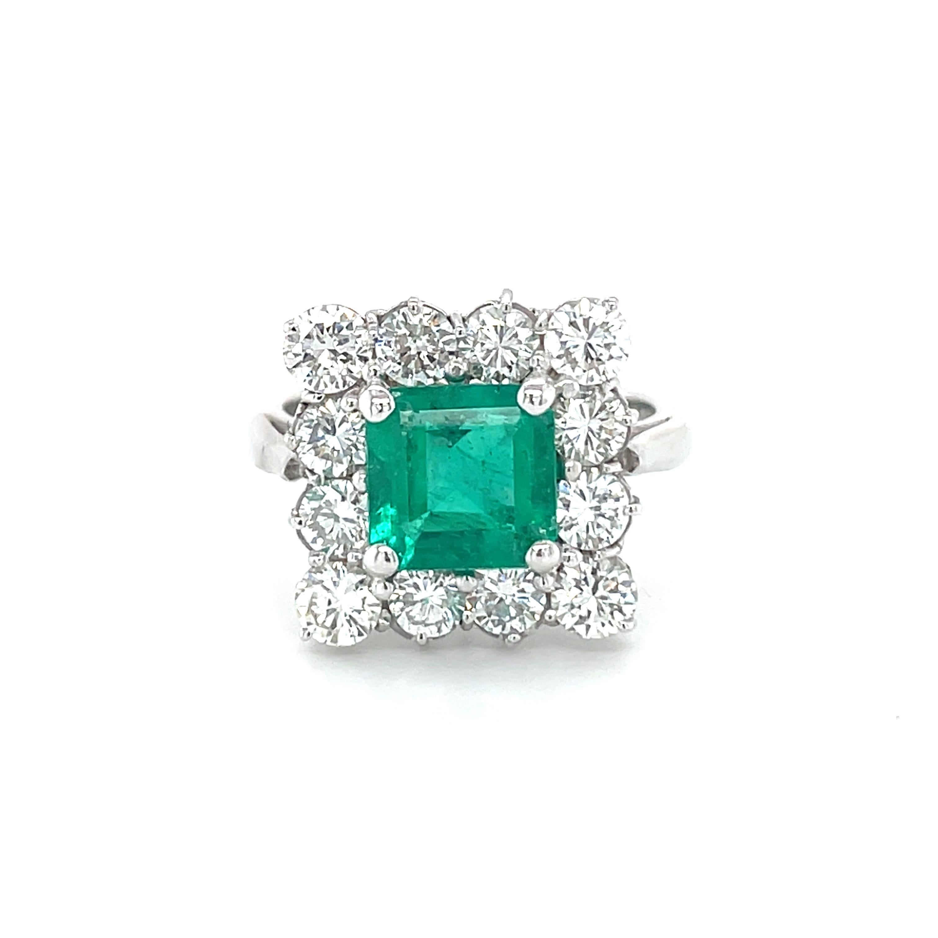 This 18K white gold stunning ring is from our Timeless Collection. It is made of a beautiful square cut emerald 1.72 Carat decorated by natural colorless round brilliant diamonds in total of 1.65 Carat. Total metal weight is 5.42 gr.  Extraordinary
