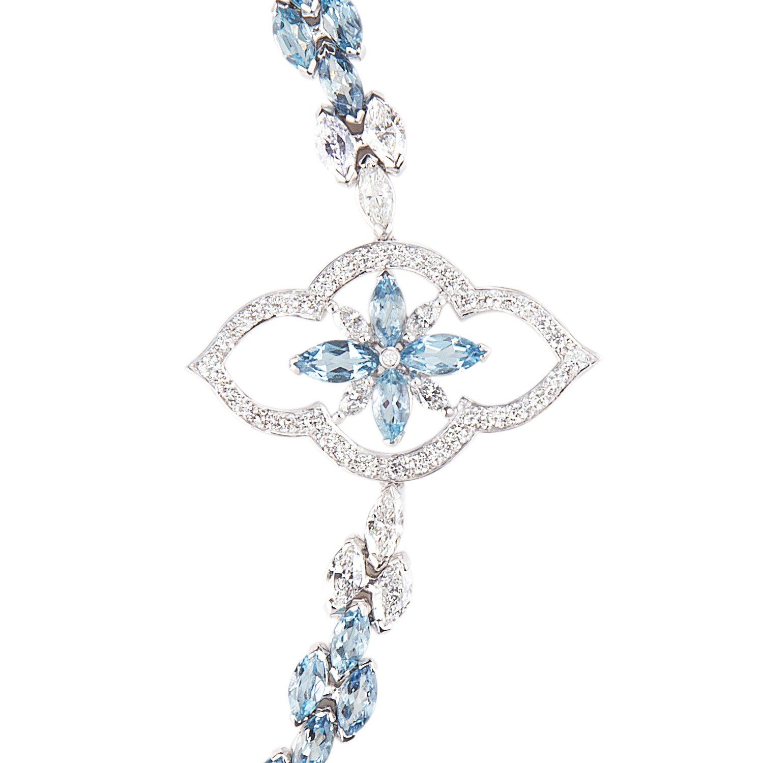 The delicate beauty of a flower, exquisitely suspended upon a sparkling garland which wraps elegantly around the wrist, depicted in marquise cut aquamarines and brilliant cut diamonds.

Details
Stella Aquamarine and Diamond Bracelet
- 18 karat White