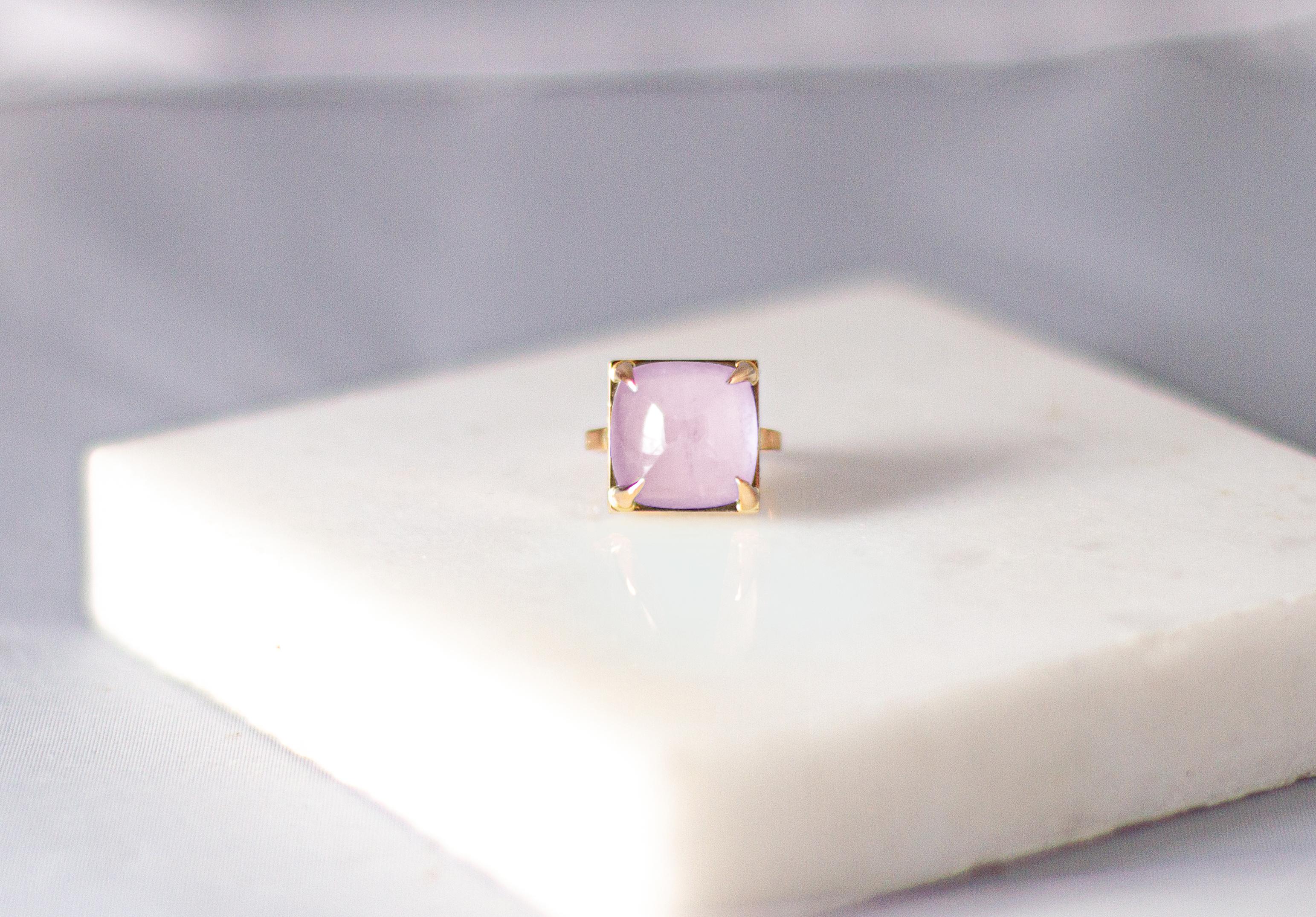 This Engagement ring is made of 18 karat white gold with sugarloaf cut natural light pink quartz. 

When for most of the gem it works the way: the smaller prongs the better. This is the shape and size of the gem that we really enjoy to see avoiding