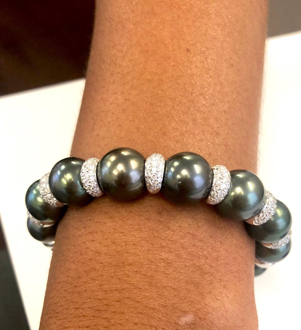 Our most popular design we produce of this style spring-on Bangle Bracelet, made in 18 Kt White Gold, set with 196 Diamonds  and Tahitian Black Pearls 12.7 to 11.0 mm. Also available with South Sea Pearls ad natural color Golden Pearls.
Many of our