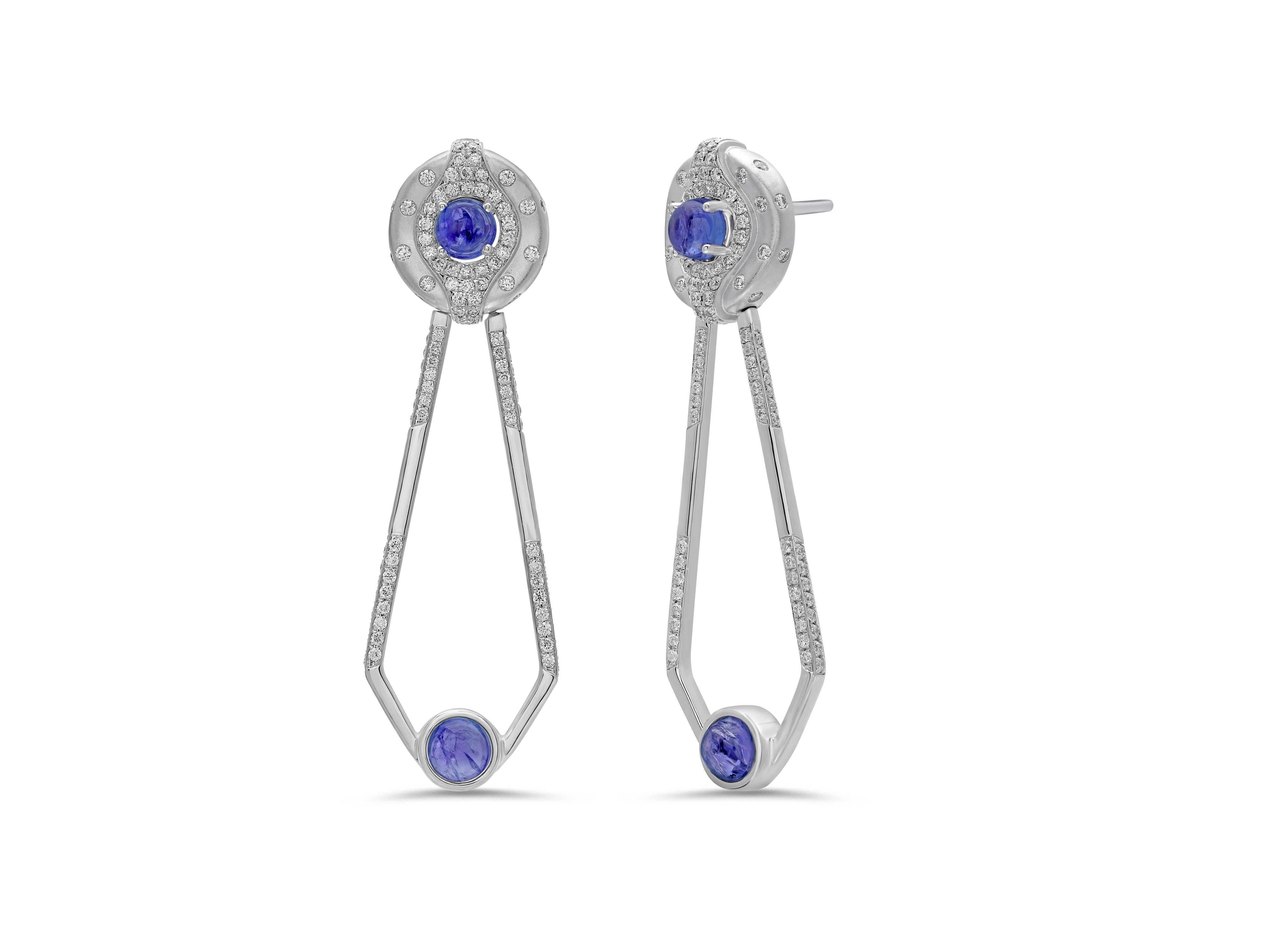 A distinct gemstone setting and varying textures combine to create the playful yet sophisticated look of Atelo’s Gypsy Collection.

These diamond earrings with tanzanite cabochons use various textured gold finishes and the distinct “gypsy” setting,