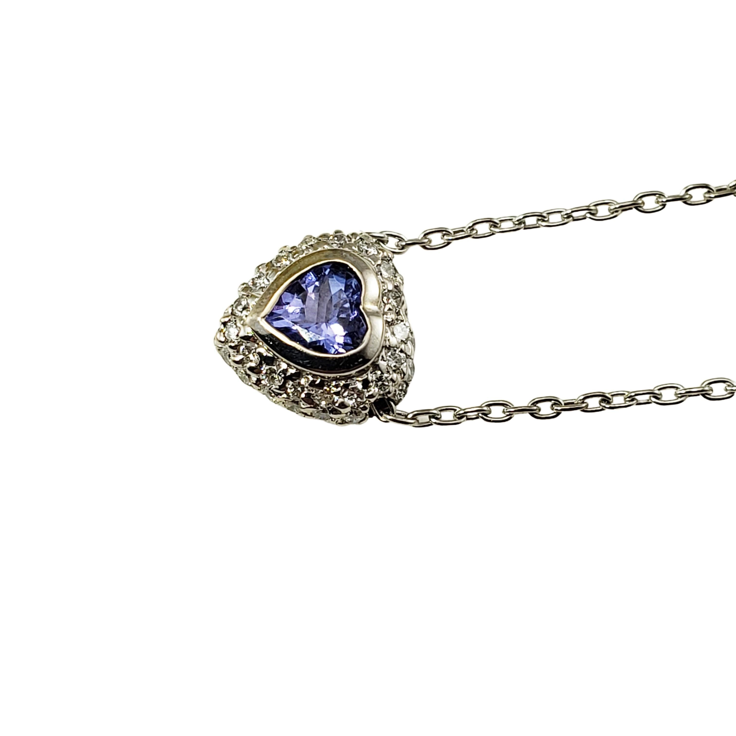 18 Karat White Gold Tanzanite and Diamond Heart Pendant Necklace-

This stunning heart pendant necklace features one tanzanite heart shaped gemstone (6 mm x 5 mm) surrounded by 36 round brilliant cut diamonds set in beautifully detailed 18K white