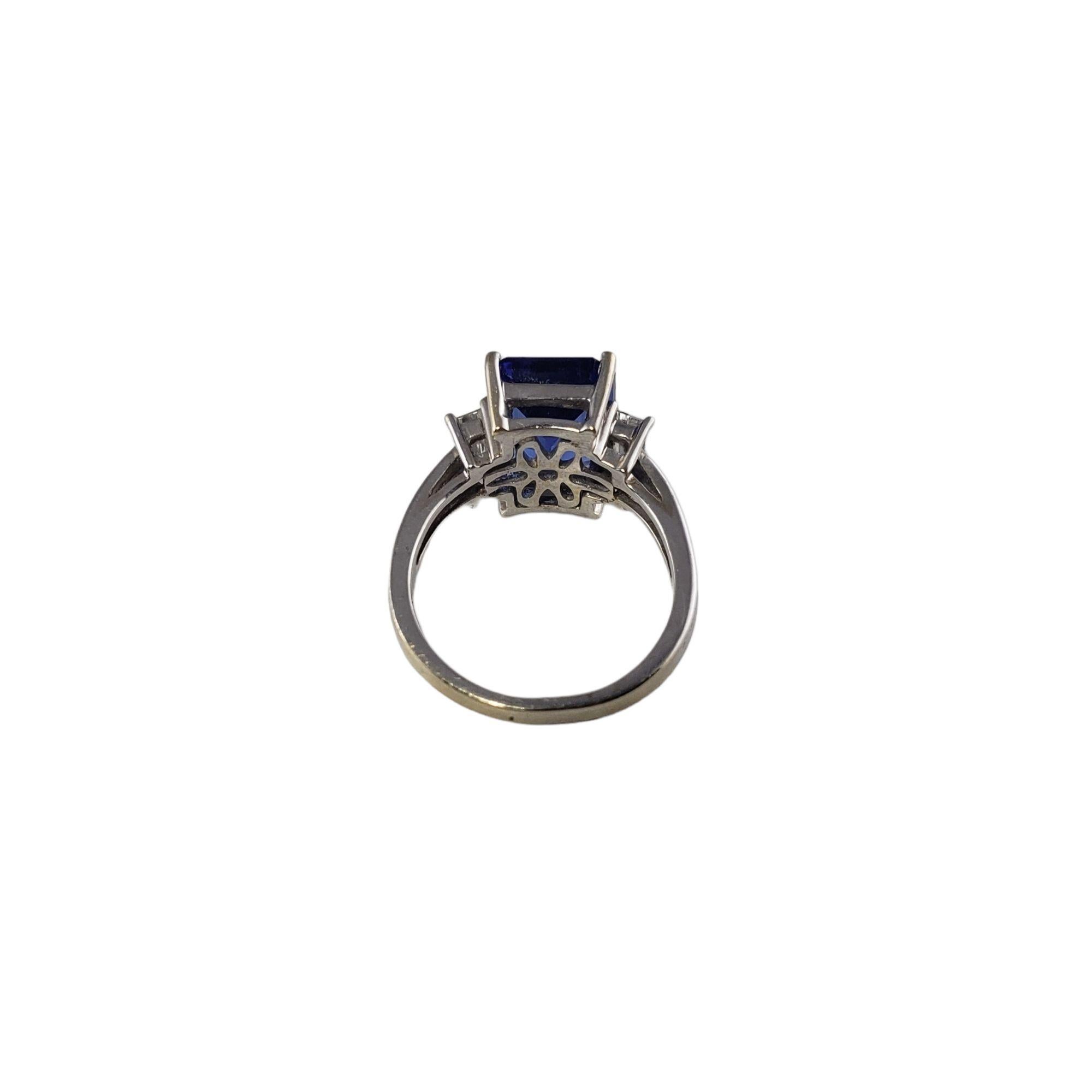 Vintage 18 Karat White Gold Tanzanite and Diamond Ring Size 5.75 JAGi Certified-

This stunning ring features one emerald cut tanzanite (12 mm x 10 mm) and two baguette cut diamonds set in classic 18K white gold. Shank: 2 mm.

Tanzanite weight: 6.92