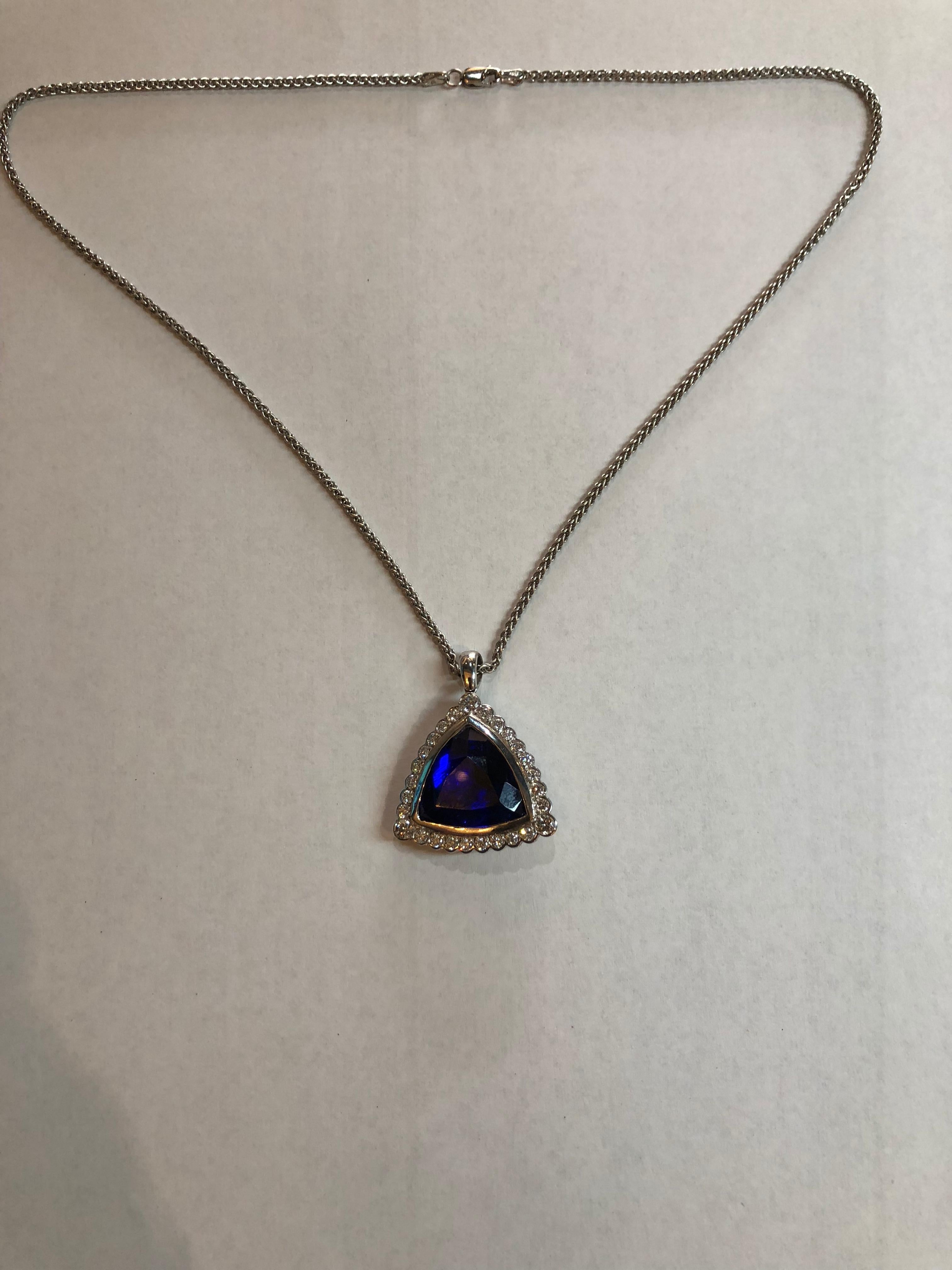 Pendant and Chain Combination 18K White Gold Weighing 19.0 Grams
Pendant contains a Tanzanite of fine quality, judged to be Near Flawless clarity and extra fine color of Medium tone and high intensity
Excellent Cut Trilliant measures approx 19.2mm