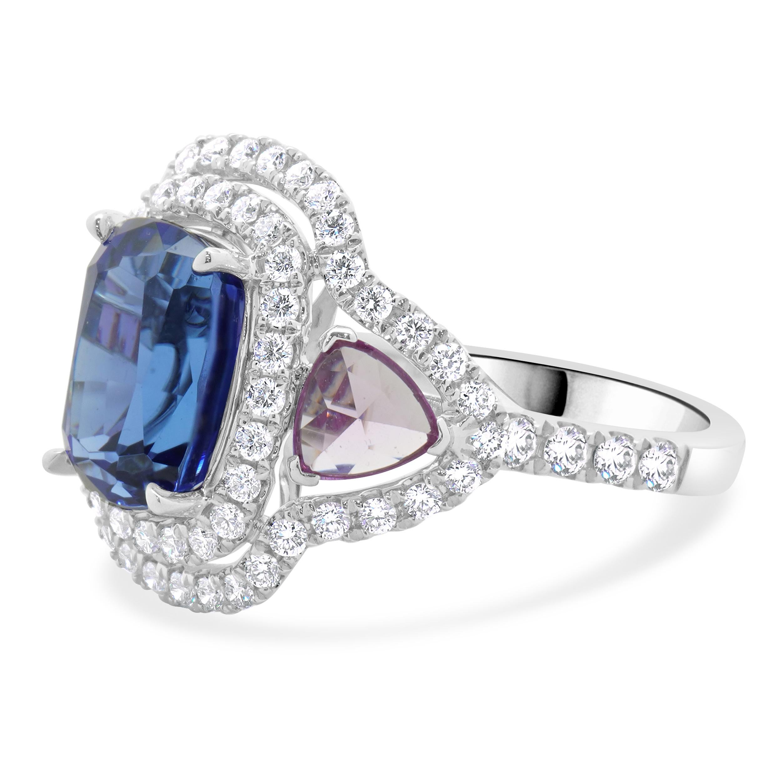 Material: 18K white gold
Diamond: round brilliant cut = .90cttw
Color: G
Clarity: VS2
Tanzanite: 1 cushion cut = 4.48cttw
Pink Sapphire: 2 rose cut trillions = 1.00cttw
Ring Size: 6.5 (please allow up to 2 additional business days for sizing