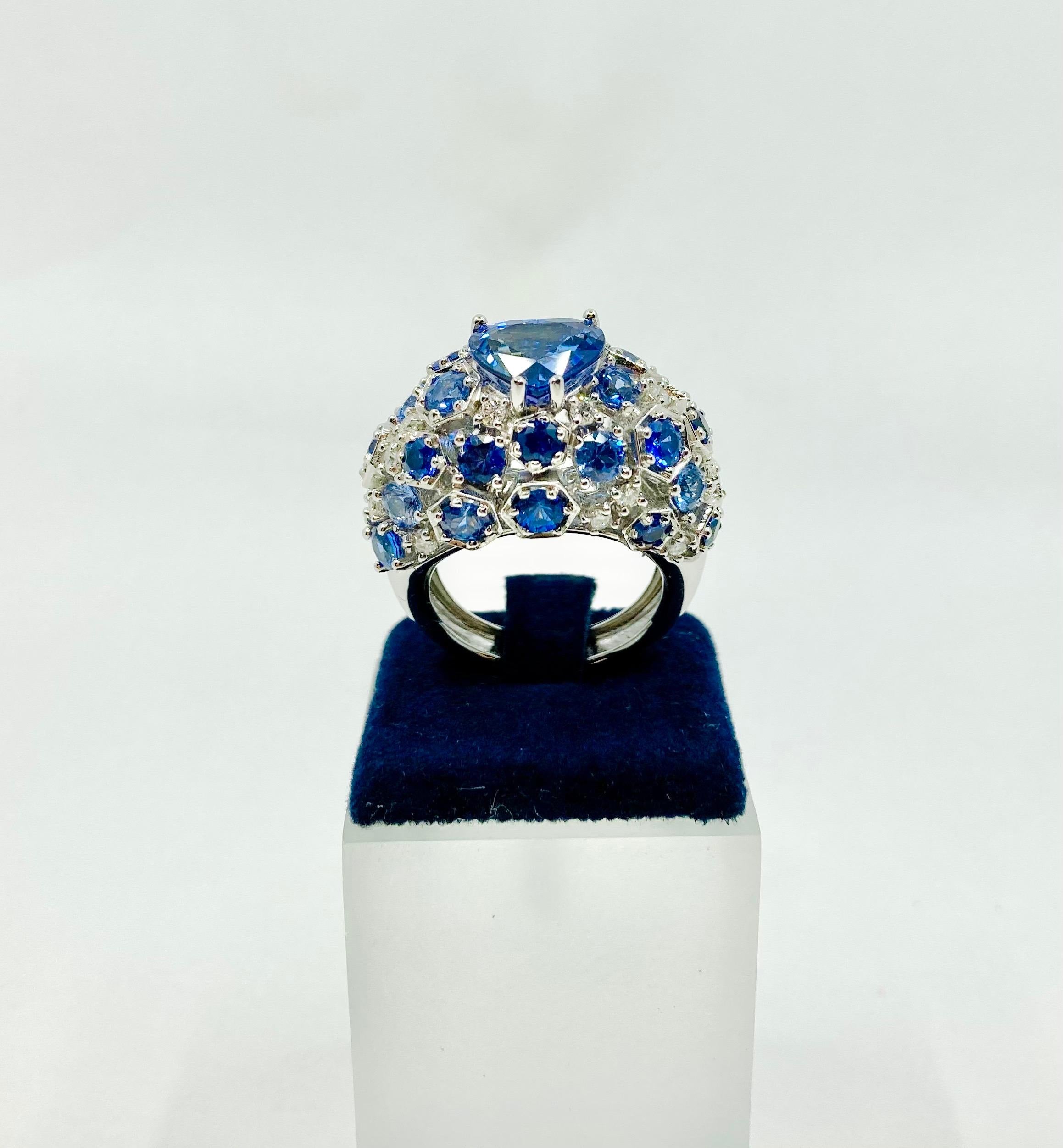 Timeless stunning White Gold ring, with a central heart shape Tanzanite ct. 0.54, round Blue Sapphires ct. 5.39 and Diamonds ct. 0.54, made in Italy by Roberto Casarin. 

Size: 14 EU (7 USA)

This ring might be the perfect gift for loved ones whom