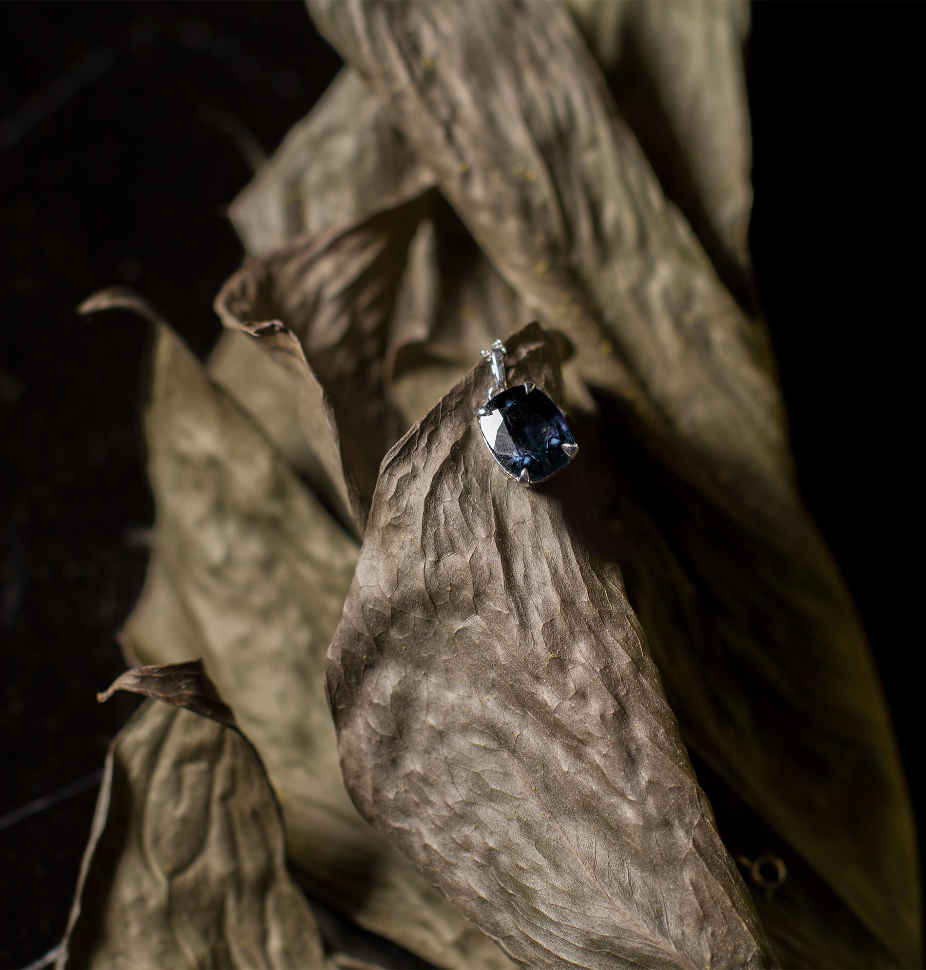 This contemporary pendant necklace is in 18 karat white gold with unheated natural dark blue cushion sapphire. It belongs to Tea collection, which was featured in Vogue UA. 

Tea collection starts with first tiny charm. This ring is the second piece