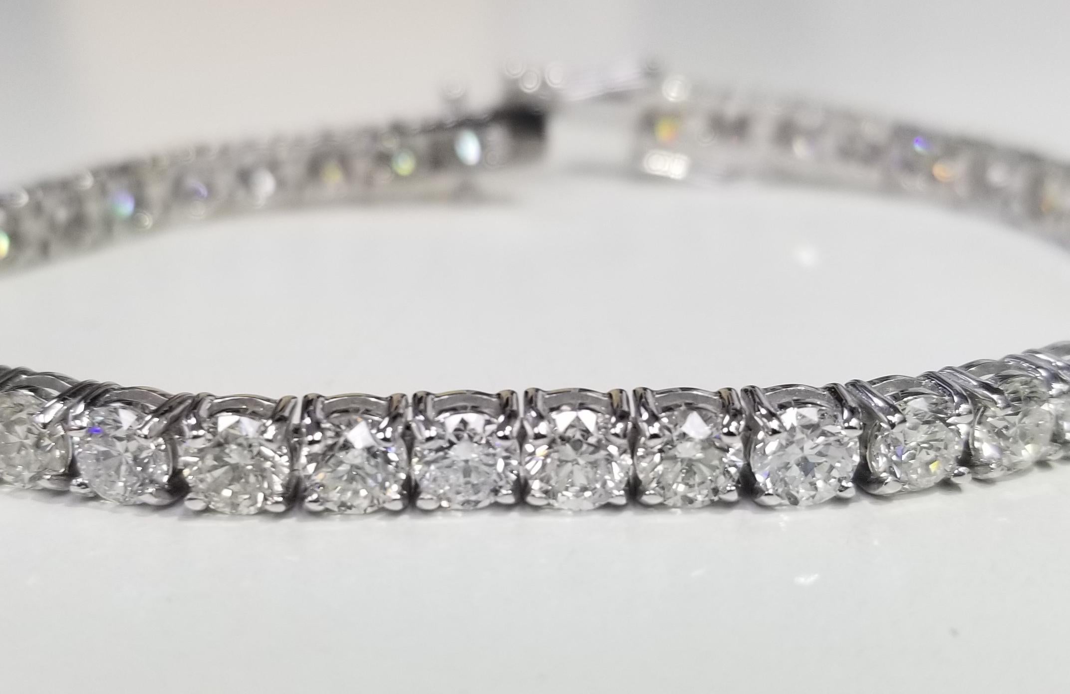 This is very beautiful 18k white gold custom made tennis bracelet with 40 round diamonds color F-G and clarity SI1 weighing 12.30cts. very fine quality diamonds, bracelet measures 7 inches with clasp and safety.
Specifications:
main stone: ROUND