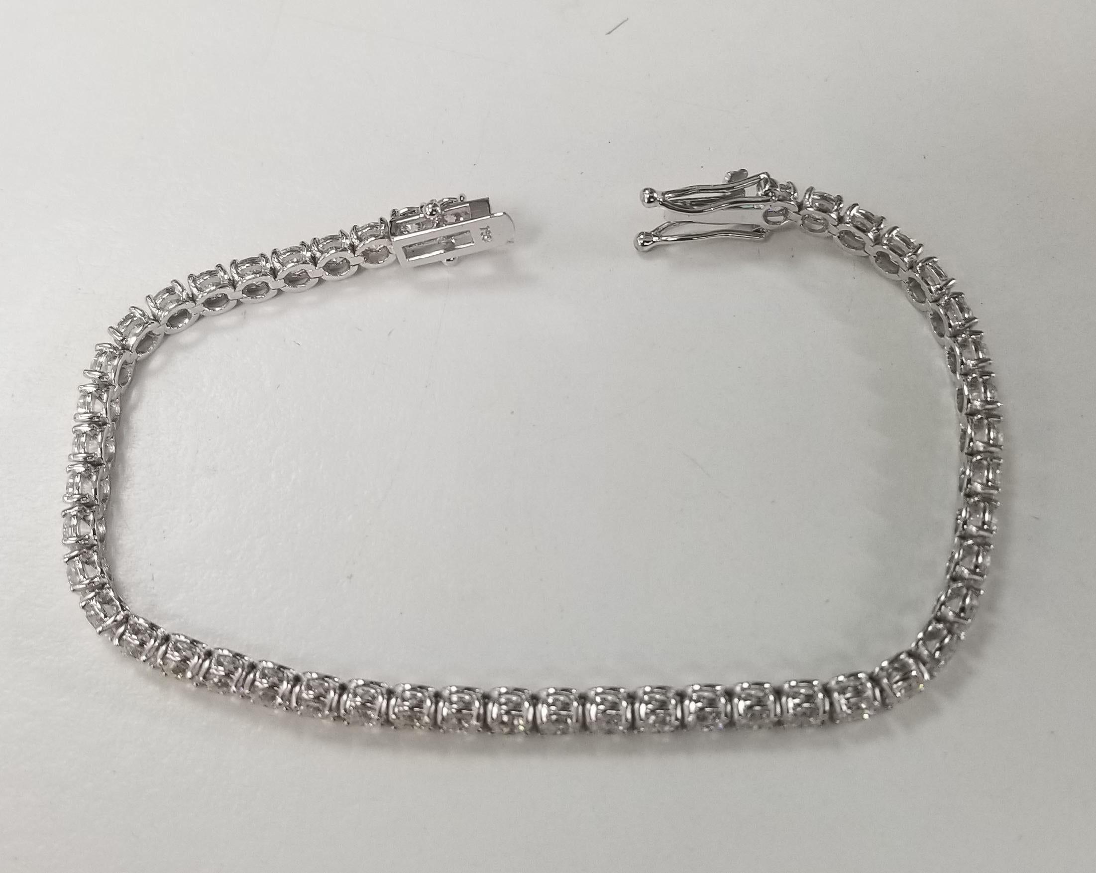 This is very beautiful 18k white gold custom made tennis bracelet with 47 round diamonds color F-G and clarity VS2-SI1 weighing 8.60cts. very fine quality diamonds, bracelet measures 7 inches with clasp and safety.
Specifications:
    main stone: