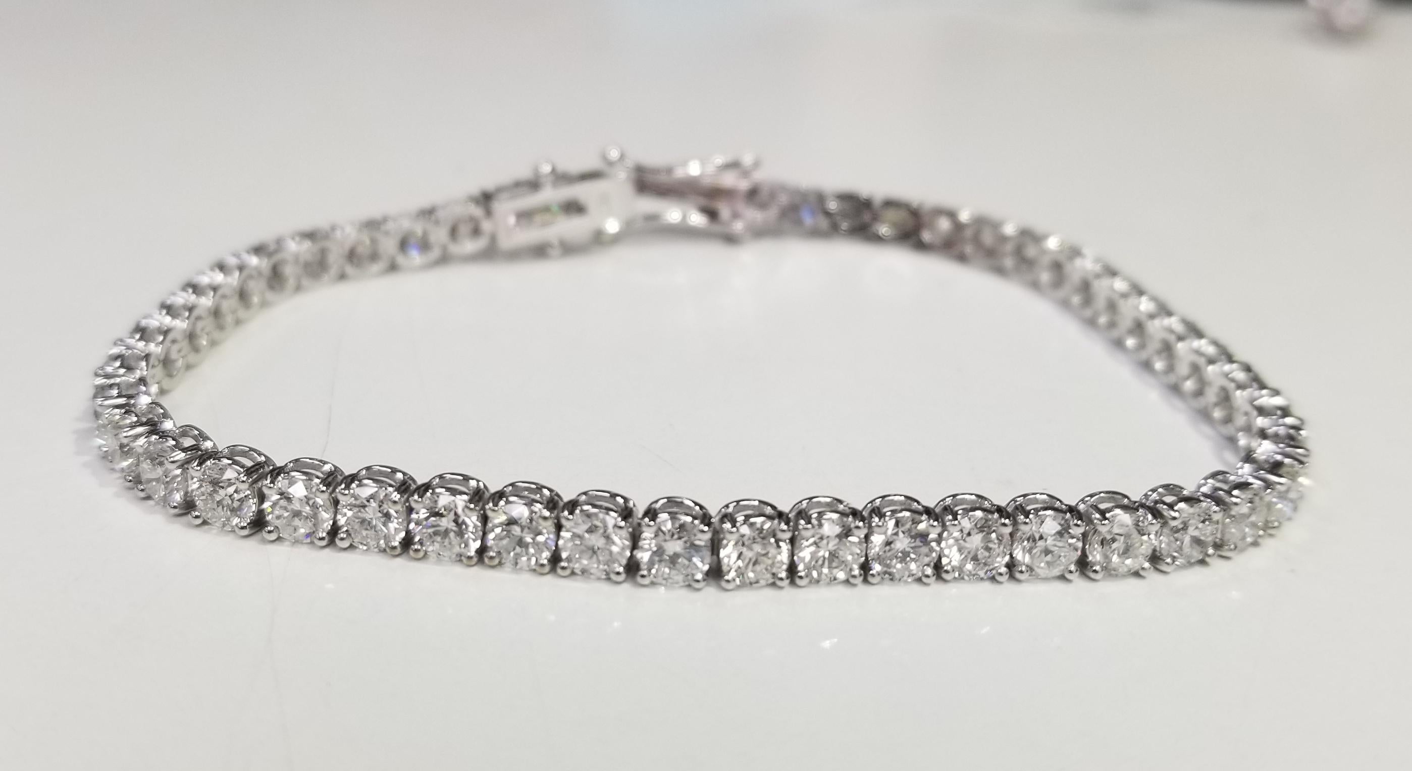 This is very beautiful 18k white gold custom made tennis bracelet with 47 round diamonds color F-G and clarity VS2-SI1 weighing 8.75cts. very fine quality diamonds, bracelet measures 7 inches with clasp and safety.
Specifications:
main stone: ROUND