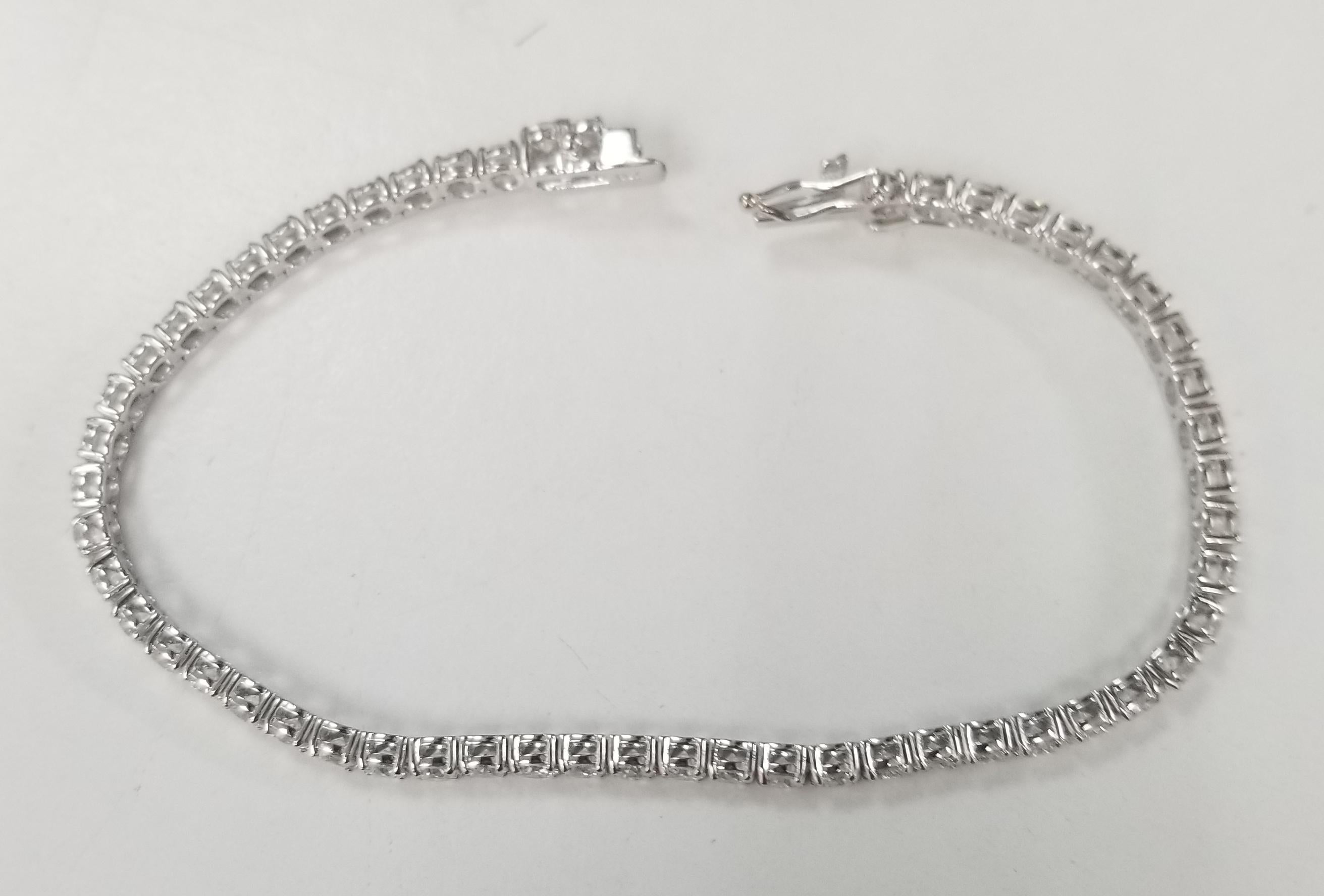 This is very beautiful 18k white gold custom made tennis bracelet with 54 round diamonds color F-G and clarity VS2-SI1 weighing 6.18cts. very fine quality diamonds, bracelet measures 7 inches with clasp and safety.
Specifications:
    main stone: