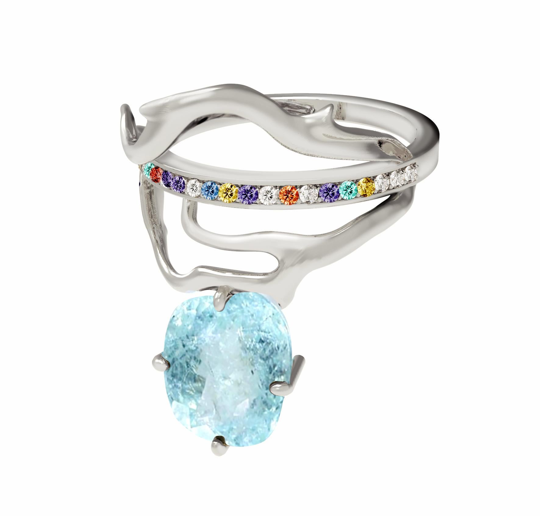 An unusual form makes this Tibetan 18 karat white gold contemporary ring an art object. It is encrusted with: colourful sapphires, diamonds, emeralds and oval paraiba tourmaline  (neon copper bearing, 2,4 carats, blue with inclusions). Size is