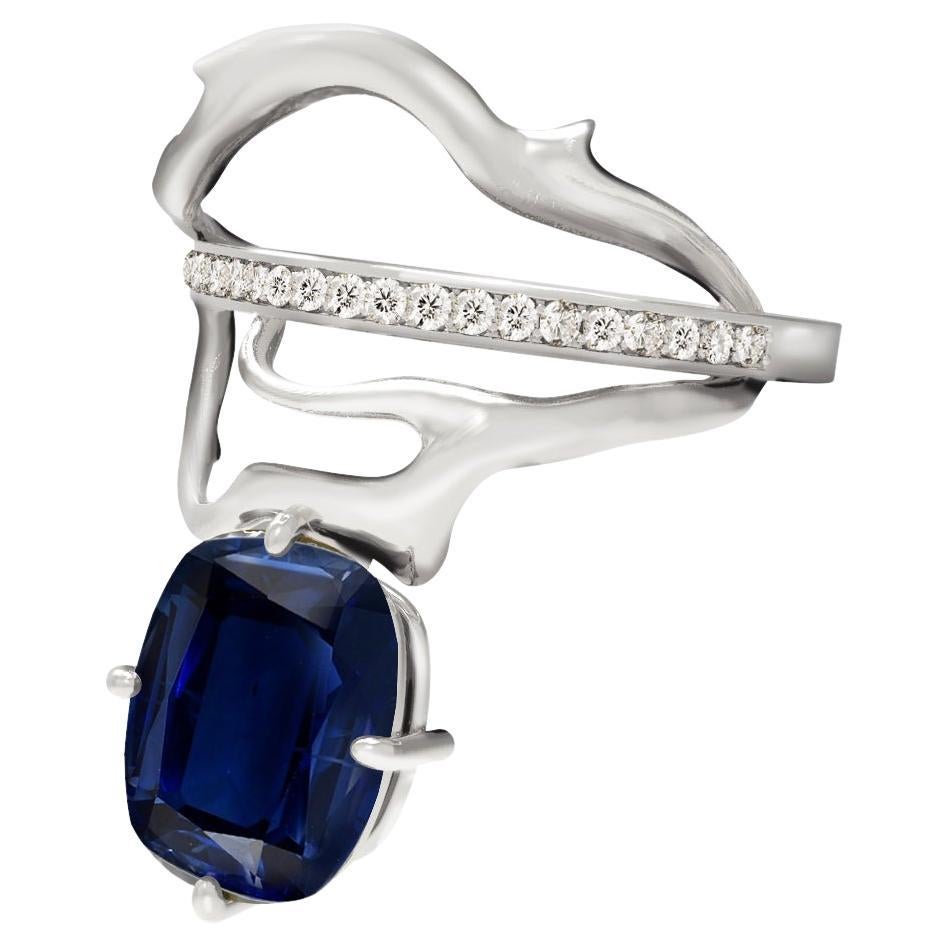 An unusual form makes this 18 karat white gold contemporary cocktail ring an art object. It is encrusted with F/G, SI. diamonds and big dark blue cushion sapphire (very dark blue). It was inspired by Tibetan culture, symbolising harmony clouds,