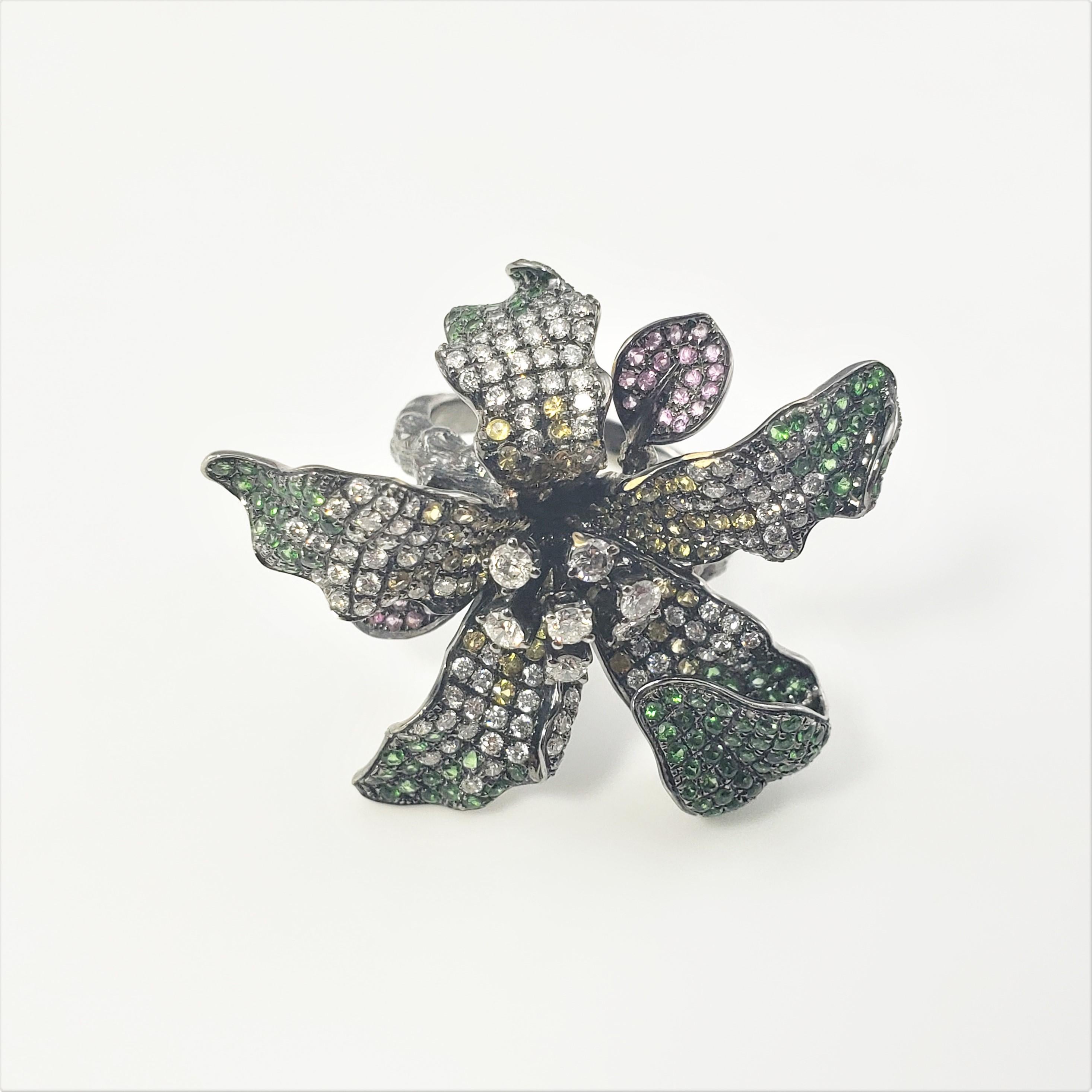 18 Karat White Gold Tourmaline and Diamond Flower Ring Size 6.75 GAI Certified-

This stunning floral ring is decorated with pink, green and yellow tourmaline gemstones and white diamonds set in oxidized 18K white gold.  Top of ring measures 3.5