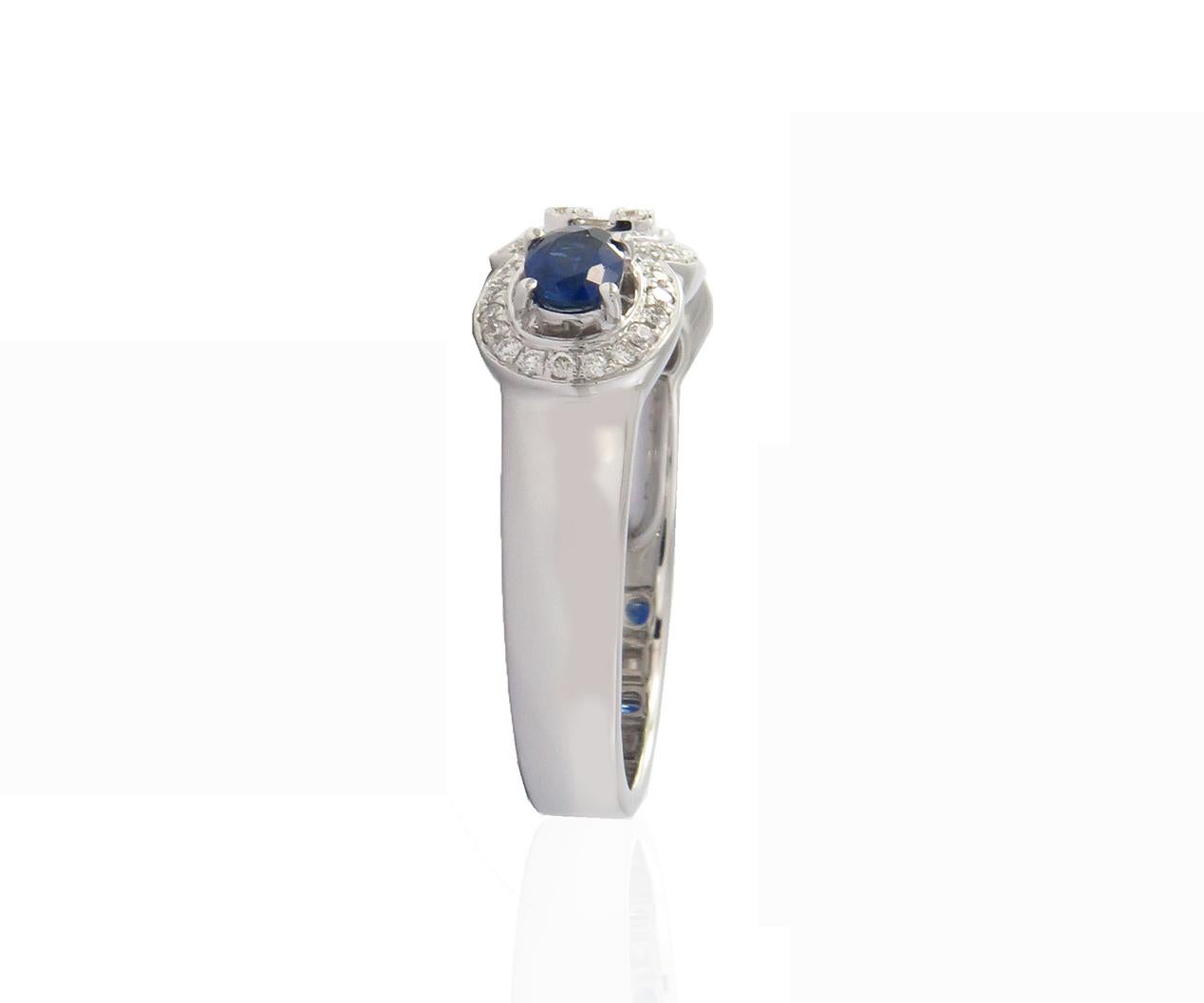 This 18K White Gold cocktail ring features a luscious Emerald shape White Diamond Illusion in Center with beautiful Sapphire stone on a side. Combine with glamorous outfits for a show-stopping effect. Each diamond hand-selected by our experts for