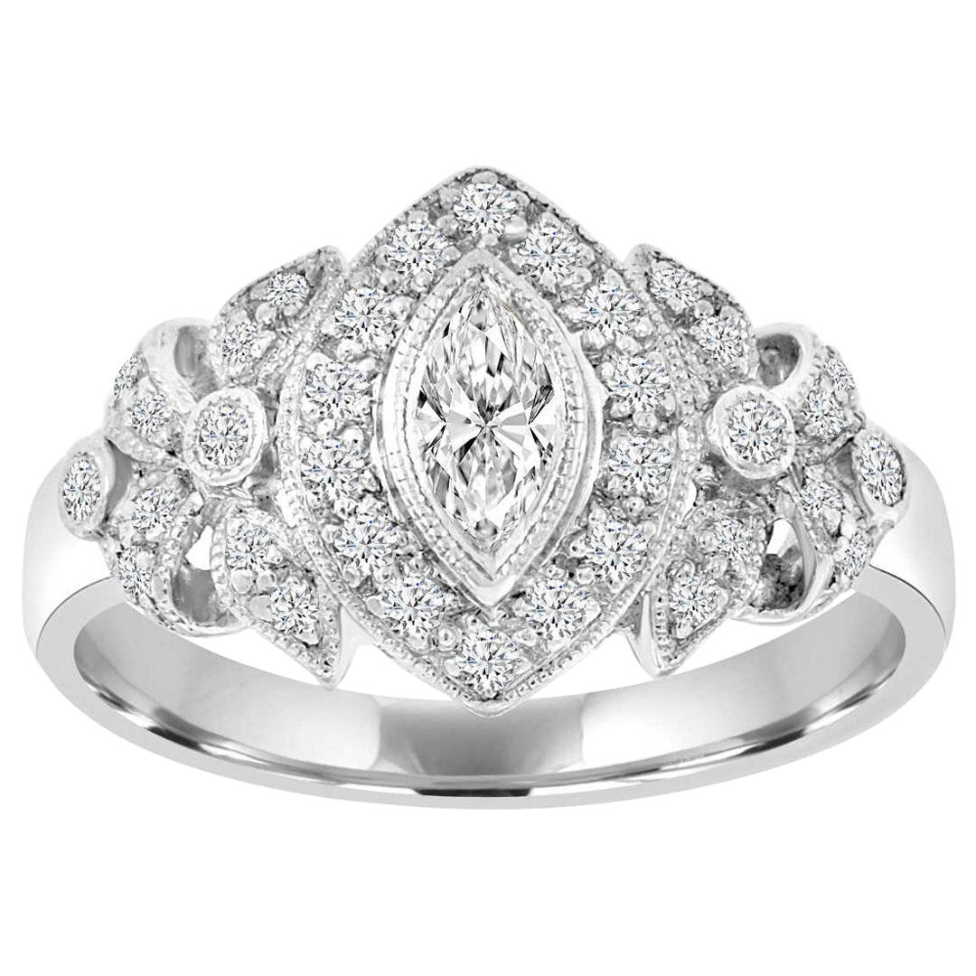 This vintage-inspired ring features a 0.24 carat Marquise shape diamond bezel set encircled by a halo of round diamonds and enchanted by a delicate flowery milgarin leafs of diamonds from each side. Twenty-eight diamonds in a total weight of 0.28