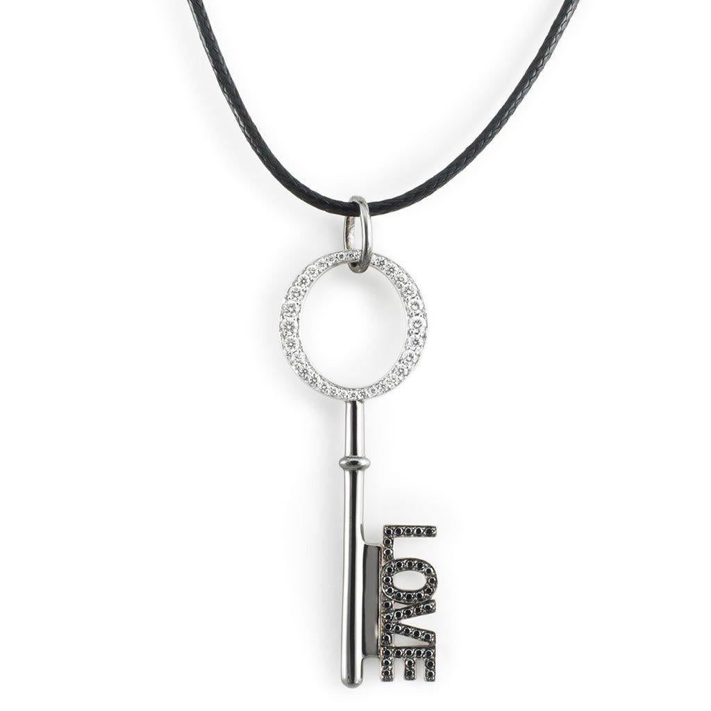 This LOVE Key Pendant with White and black diamonds is handcrafted in white gold, sterling silver, rhodium on a cotton cord.

Stones: White (F-G/VVS) and black diamonds: 0,43ct.
Material: White Gold 18k, Sterling Silver 925, Black Rhodium

The