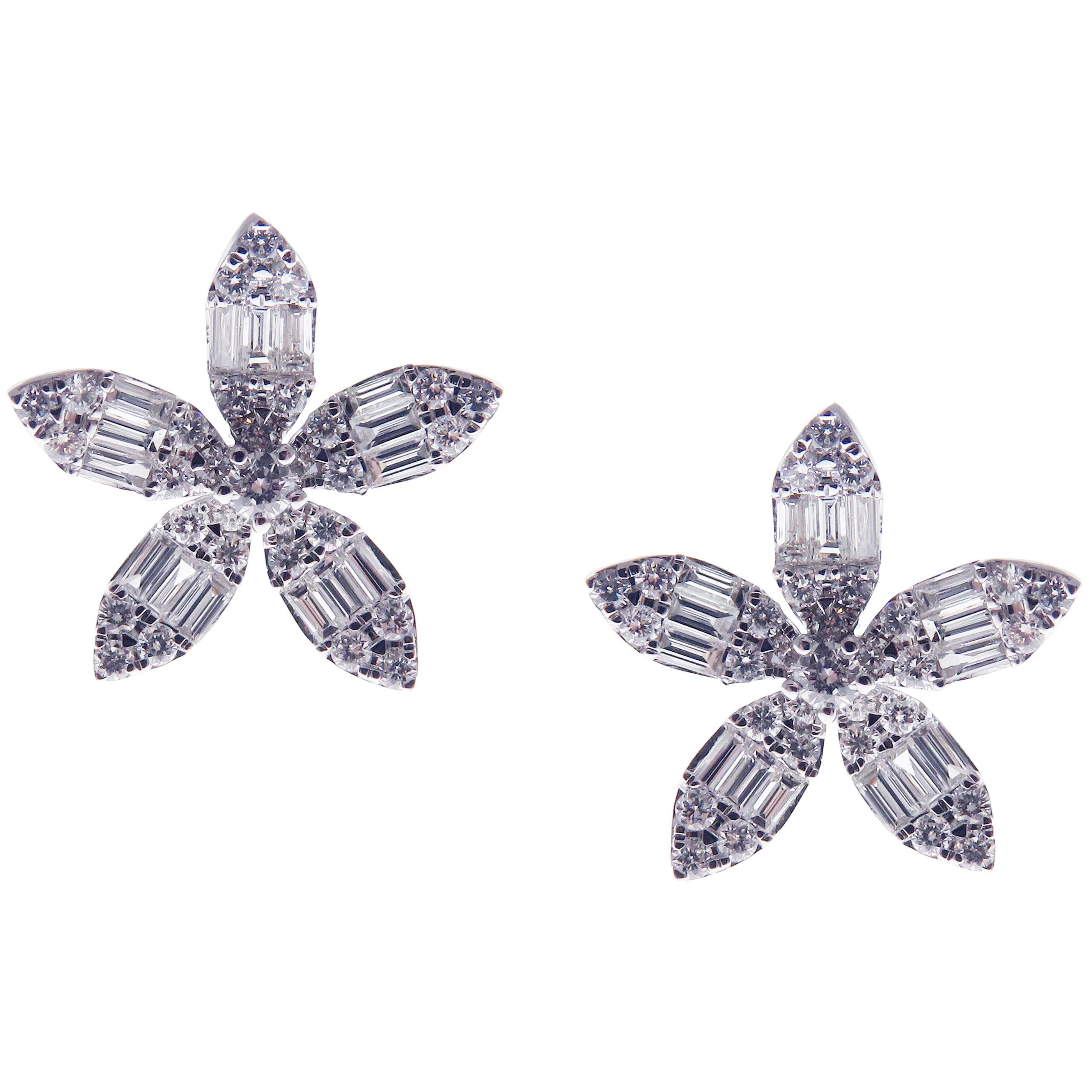 These classic flower stud earrings with round and baguette white diamonds are crafted in 18-karat white gold, featuring 62 round white diamonds totaling of 0.45 carats and 30 baguette white diamonds totaling of 0.50 carats.
These earrings come with