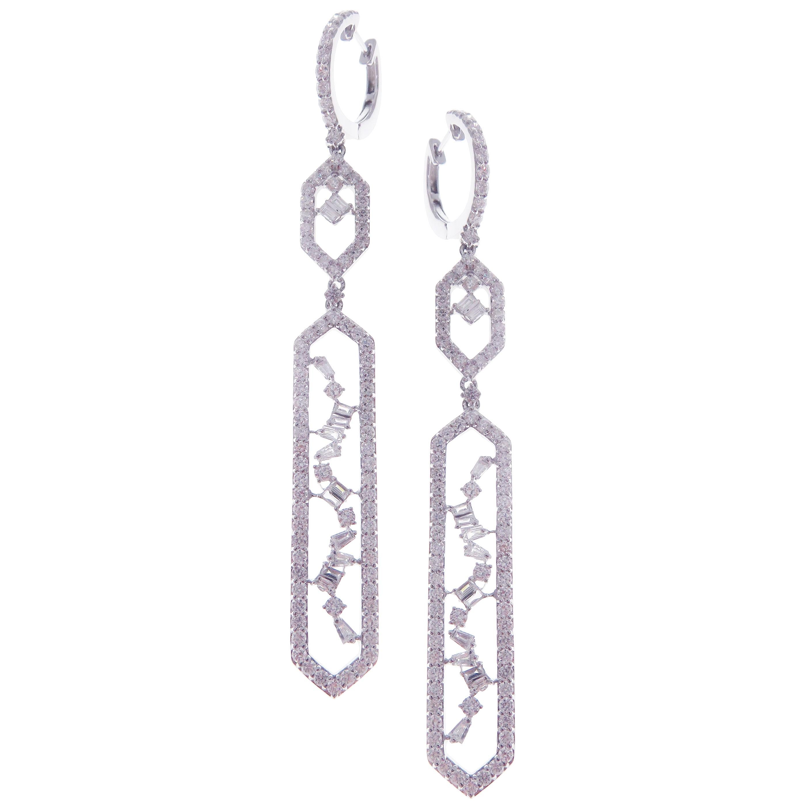 These symmetrical dangling diamond earrings are crafted in 18-karat white gold, featuring 178 round white diamonds totaling of 3.45 carats and 28 baguette white diamonds totaling of 0.66 carats.
Approximate total weight 9.21 grams.
These earrings