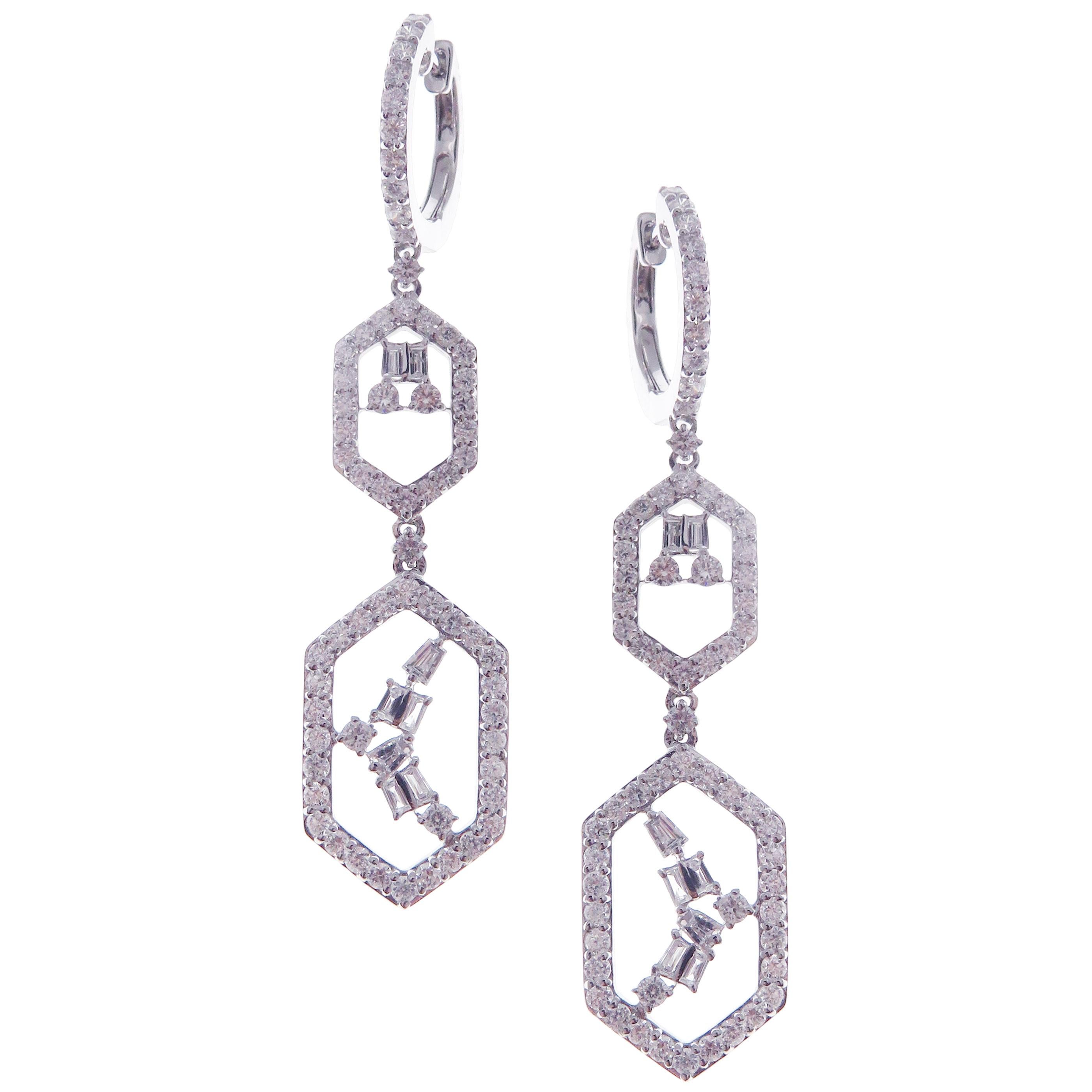These symmetrical dangling diamond earrings are crafted in 18-karat white gold, featuring 139 round white diamonds totaling of 2.36 carats and 16 baguette white diamonds totaling of 0.42 carats.
Approximate total weight 7.10 grams.
These earrings