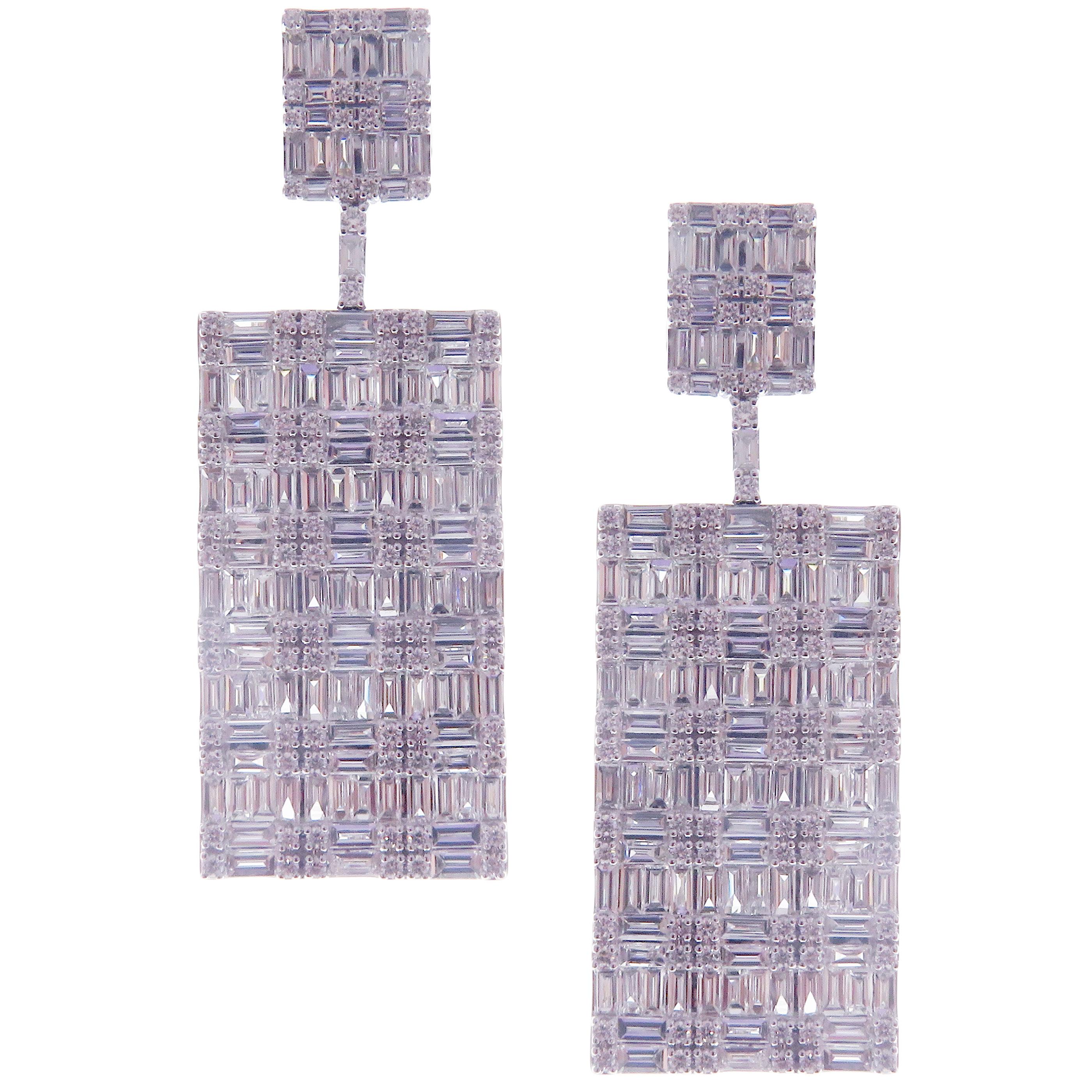 These symmetrical illusion rectangle-shape dangling diamond earrings are crafted in 18-karat white gold, featuring 180 round white diamonds totaling of 0.88 carats and 234 baguette white diamonds totaling of 5.40 carats.
Approximate total weight