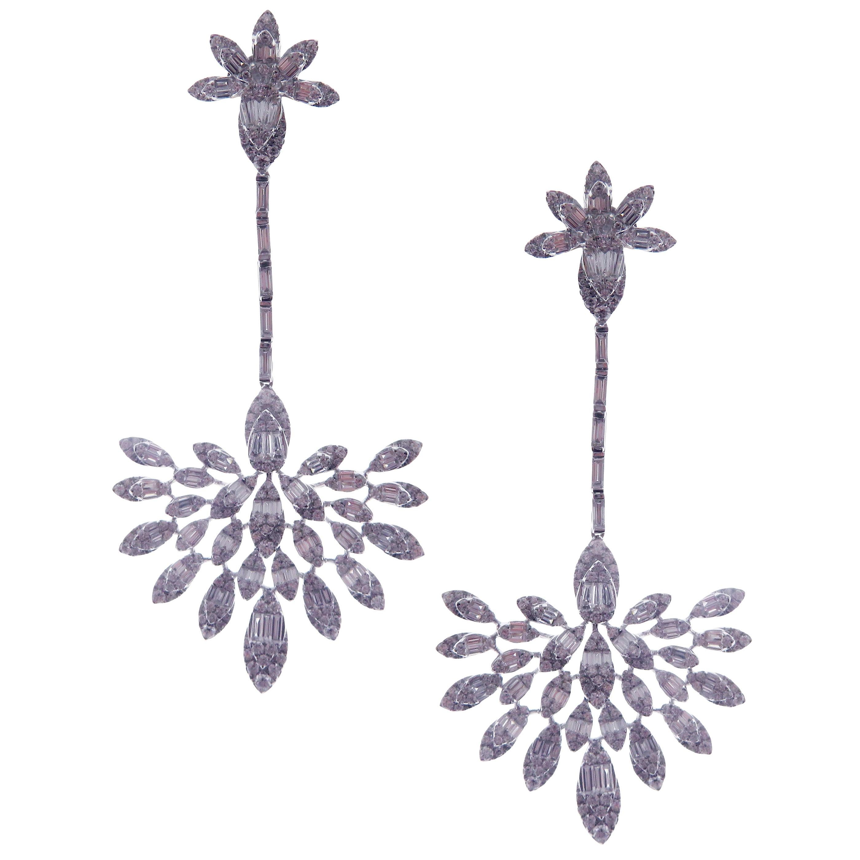 These symmetrical fan-shape dangling diamond earrings are crafted in 18-karat white gold, featuring 394 round white diamonds totaling of 3.32 carats and 170 baguette white diamonds totaling of 3.36 carats.
Approximate total weight 28.29 grams.
These
