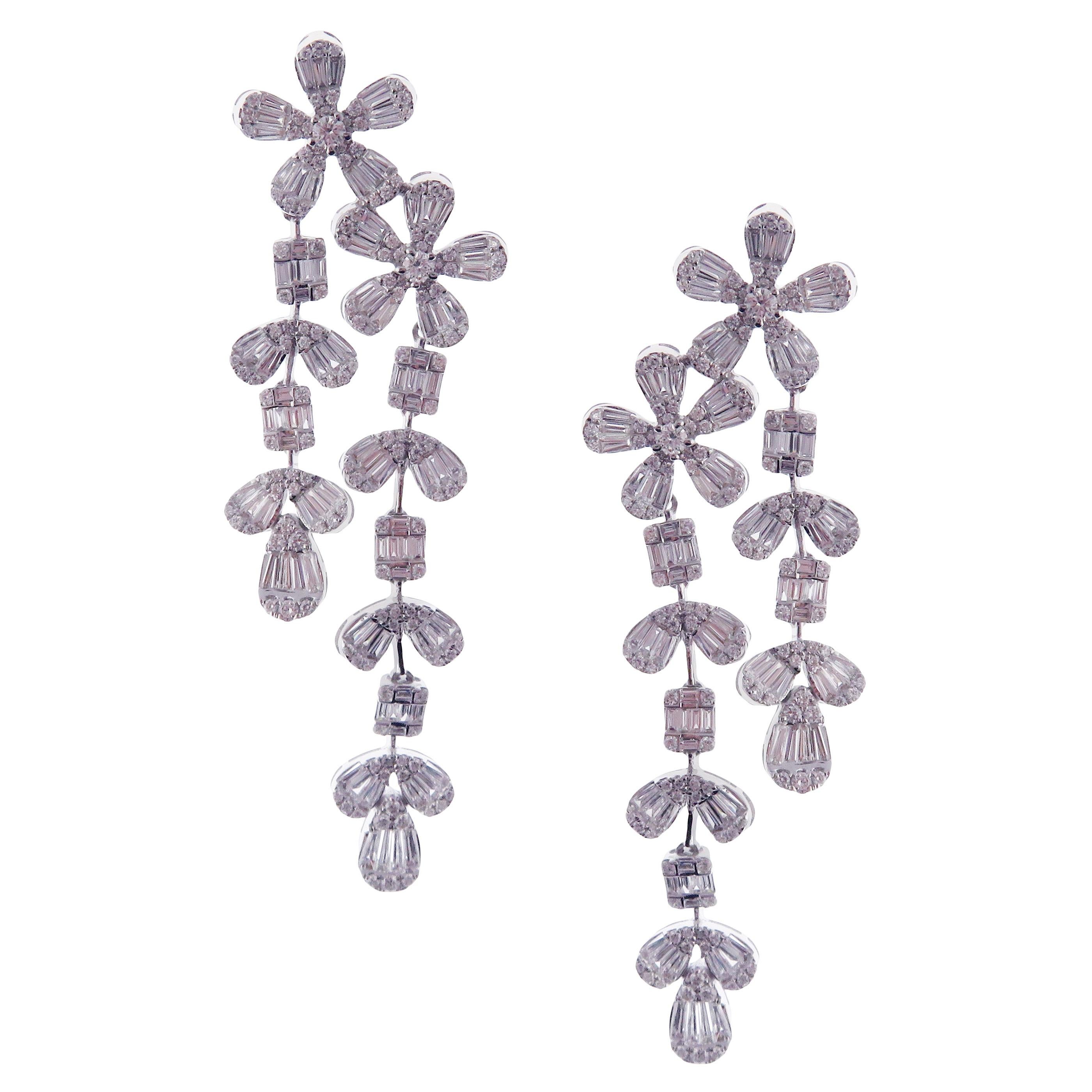 These trendy multi shapes flower waterfall dangling earrings with illusion setting round and baguette white diamonds are crafted in 18-karat white gold, featuring 308 round white diamonds totaling of 2.20 carats and 196 baguette white diamonds