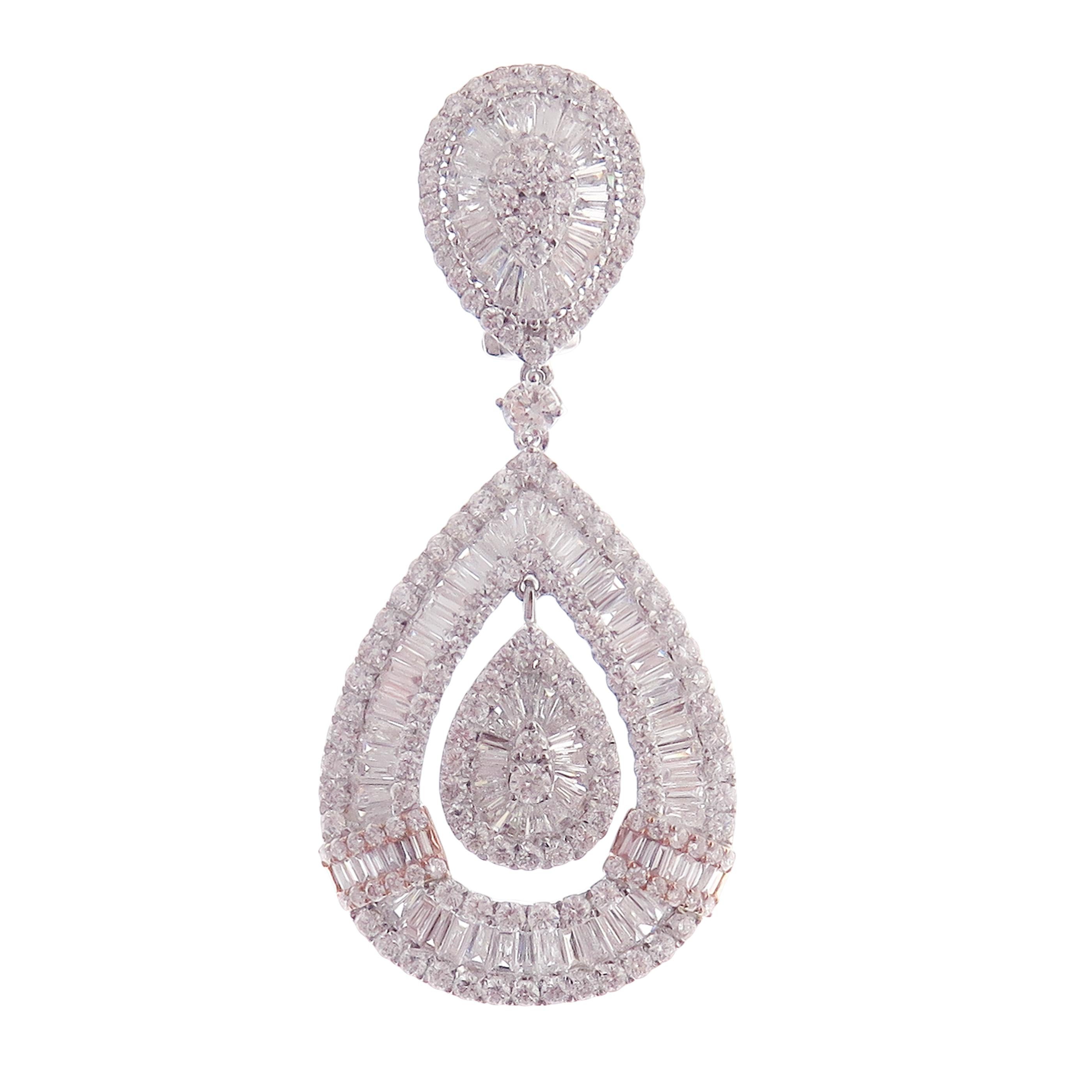 These modern pear baguette earrings are crafted in 18-karat white gold, weighing approximately 11.82 total carats of SI-V Quality white diamond. French Clip backing. Beautiful rose gold accent.

Our Ballroom Collection feature earrings for those