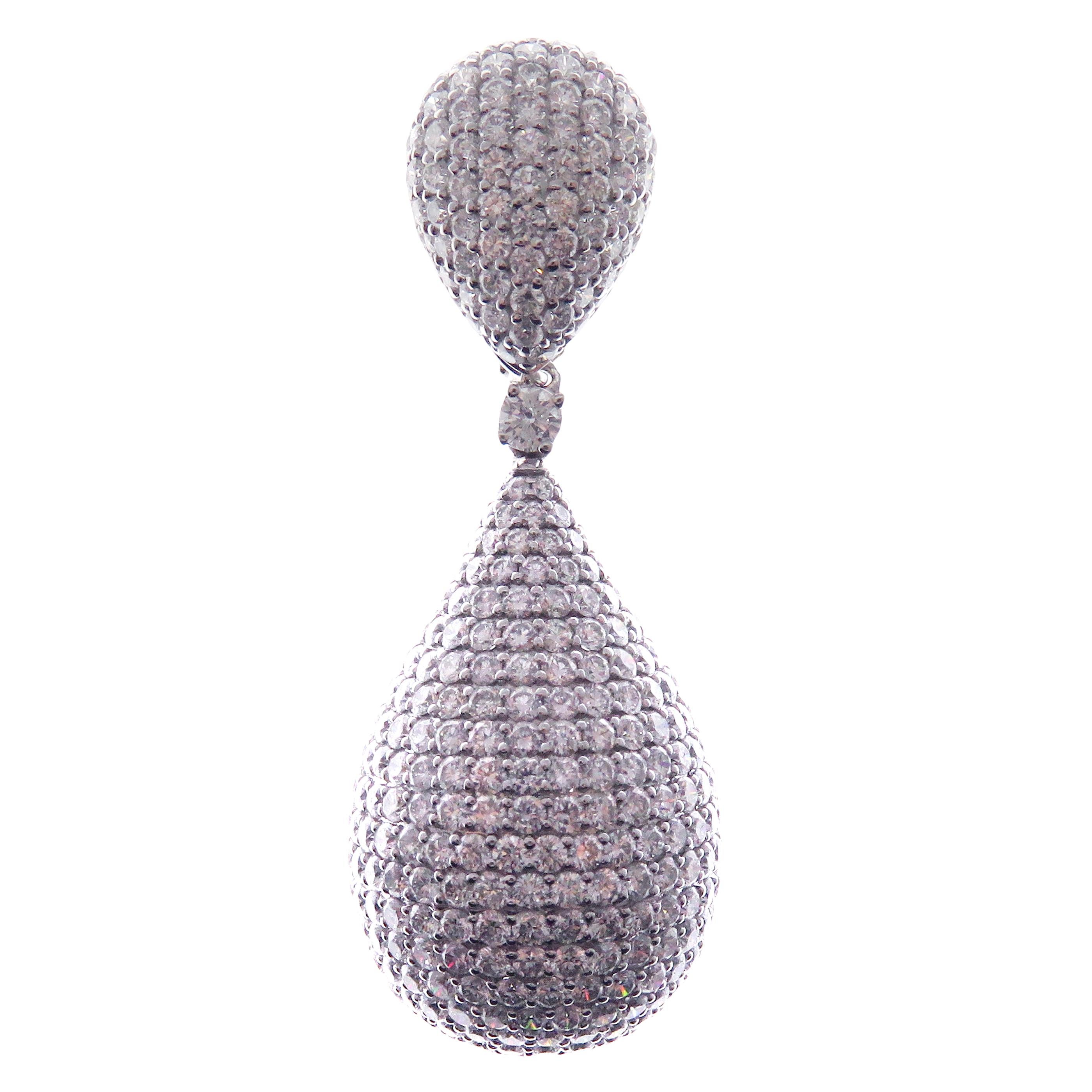 These pear drop pave earrings are crafted in 18-karat white gold, weighing approximately 24.16 carats of V-Quality white diamond with 1090 round diamonds. French clip backing. 

Beautiful 0.15 pt white diamond accent on each earring and