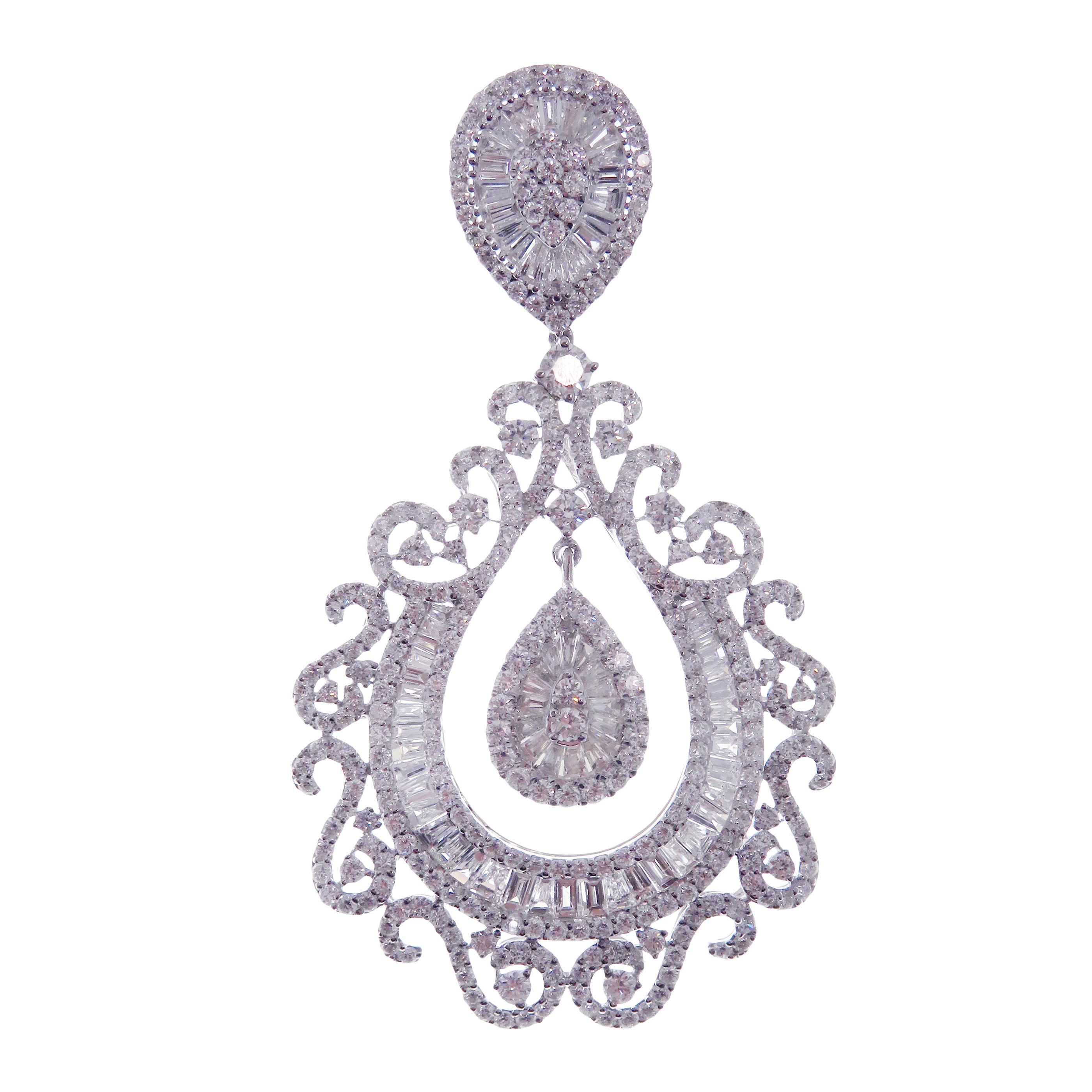 These pear swirl chandelier earrings are crafted in 18-karat white gold, weighing approximately 13.31 total carats of SI-V Quality white diamond. French clip backing. 

Our Ballroom Chandelier Collection feature earrings for those with bold/classy