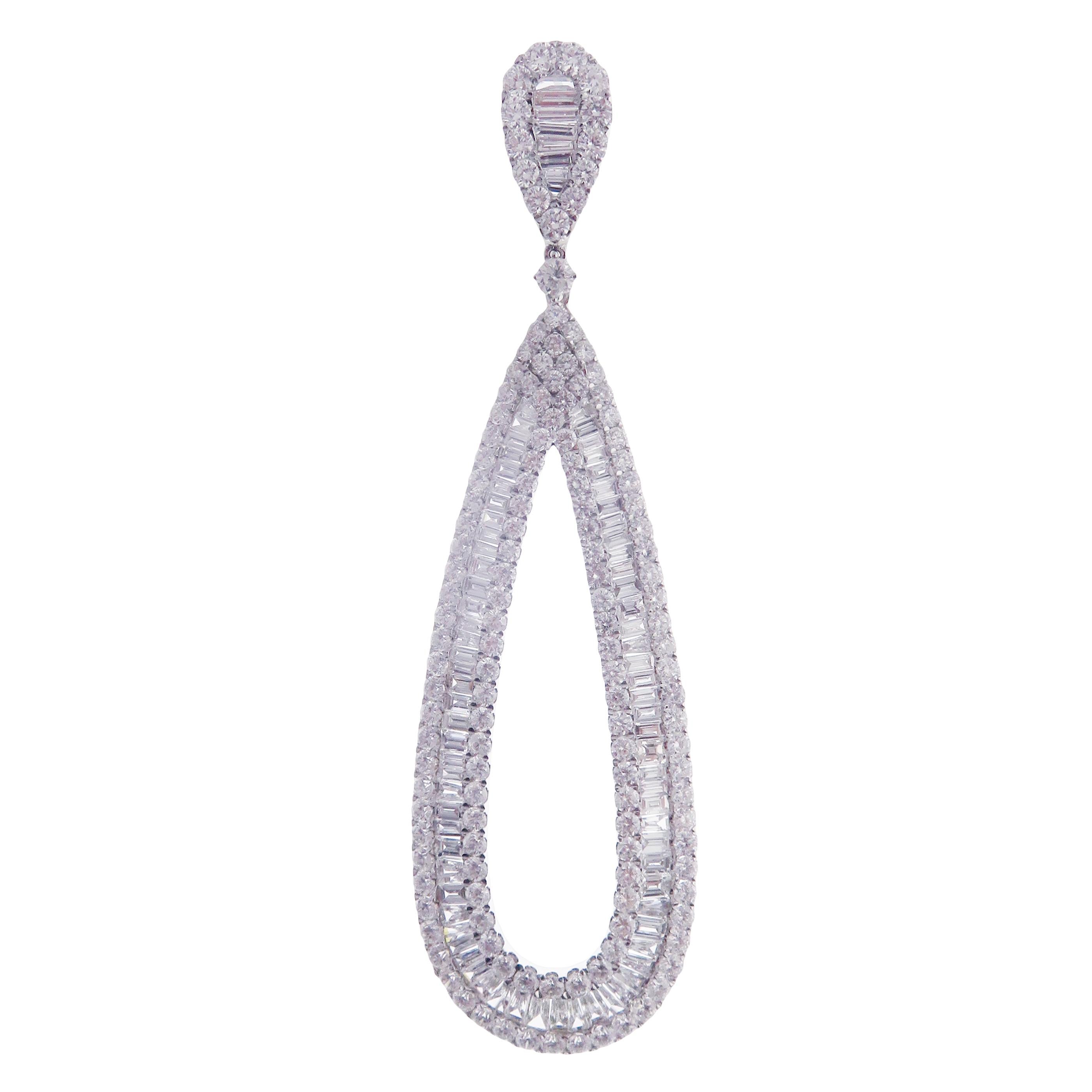 These simple baguette pear earrings are crafted in 18-karat white gold, weighing approximately 16.47 total carats of SI-V Quality white diamond. French Clip backing, 3.5