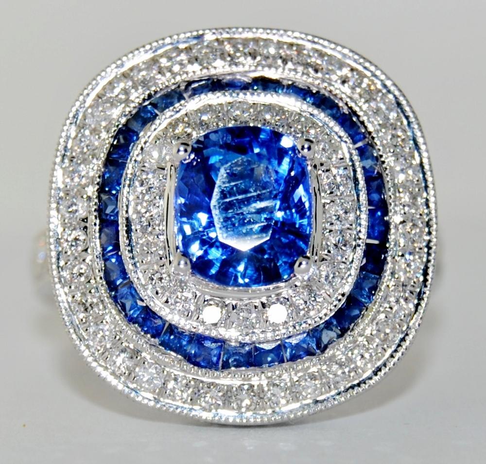 This 18-karat white gold ring has an oval shape blue sapphire at the center that weighs 2.01 carats, surrounded by .80 carats princess cut blue sapphire and 1.30 carats white round diamond.

Size 6.5
