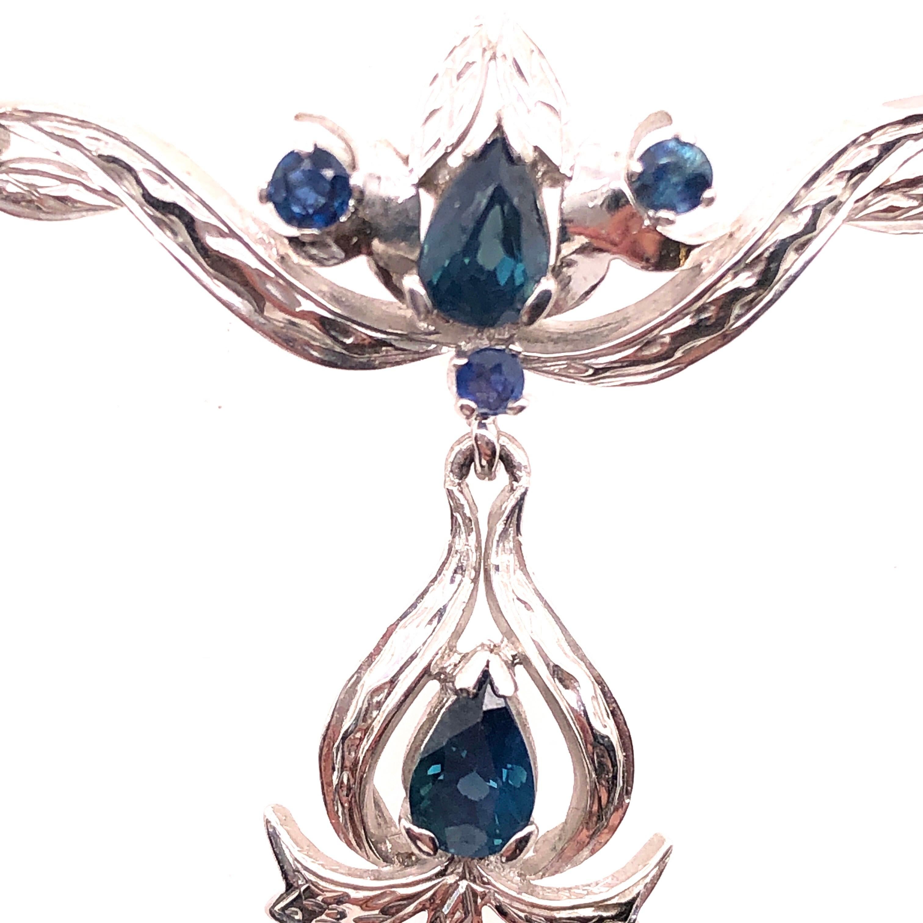 18 Karat White Gold With Blue Sapphire Drop Pendent Necklace.
20 inch Chain
Pendant: 10 cm width
                 3cm height
15.40 grams total weight
