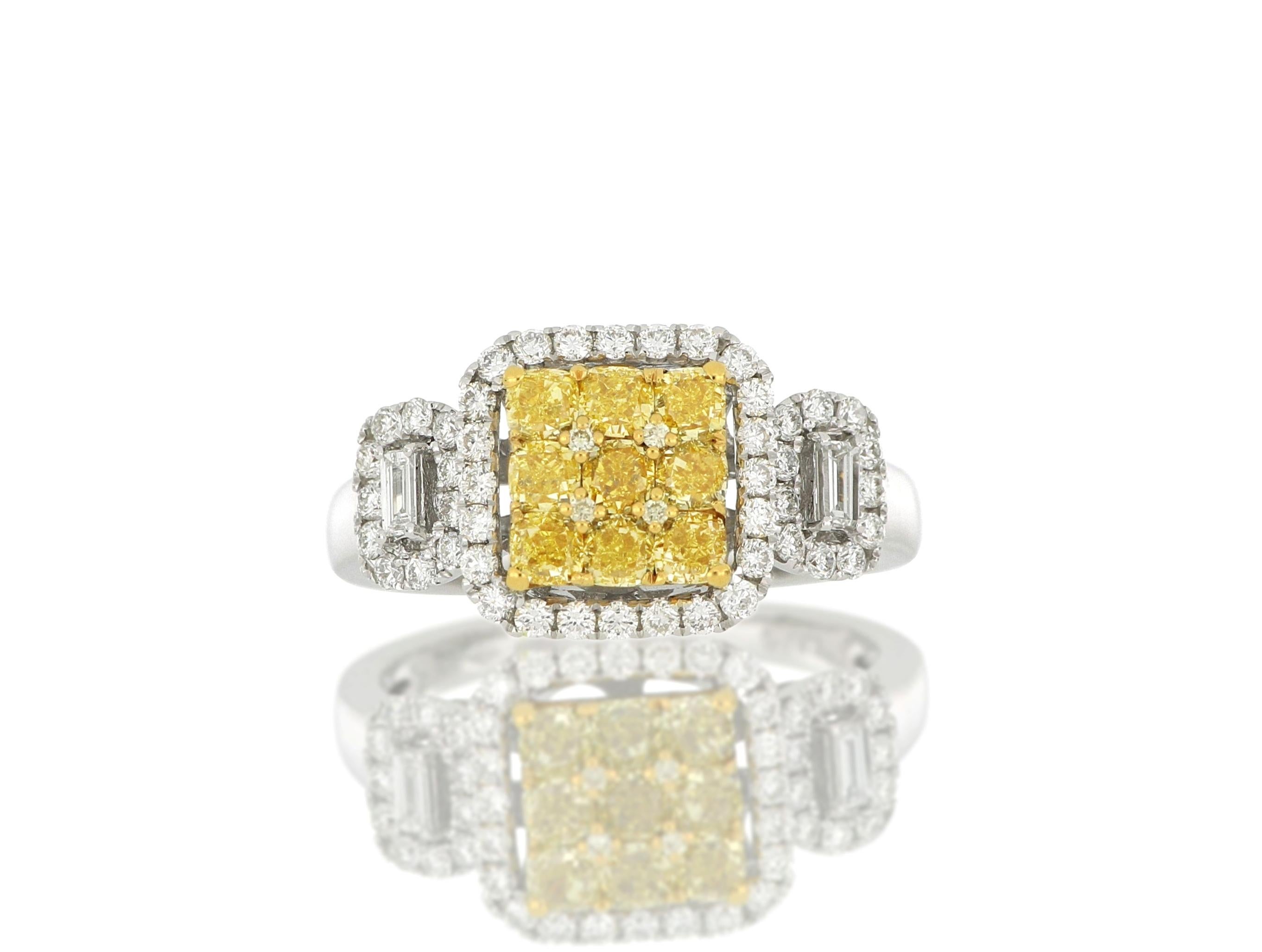 A diamond ring, set with brilliant-cut natural fancy yellow diamonds weighing approximately 1.01 carats, flanked by brilliant-cut diamonds and accented by trapeze-shaped diamonds weighing approximately 0.56 carats in total, mounted in 18 Karat white