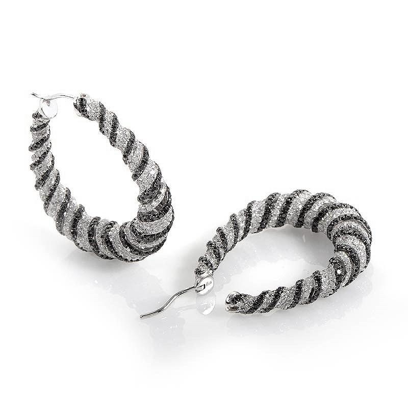 This pair of hoop earrings are fun and flirty. These earrings are made of 18K white gold and are set with ~7.83ct of black and white diamonds.