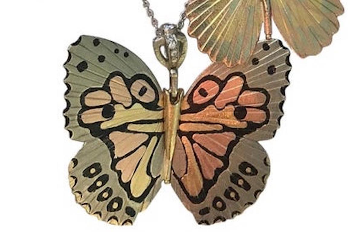 James Banks's signature butterfly necklace features a Large White Kamehameha Hawaiian Butterfly with a hinge at the center to allow movement of the wings, made of Shakudo, 18k White Palladium, 14k Rose Gold, 18k Yellow Gold with white diamond pave