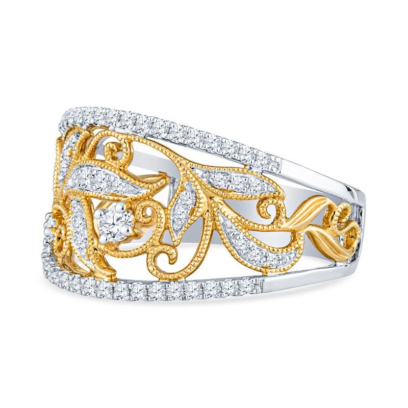 This beautiful band features floral filigree detailing accented by 0.39 carat total weight in round brilliant cut diamonds set in 18 karat white and yellow gold. This ring is a size 7 but can be resized upon request.