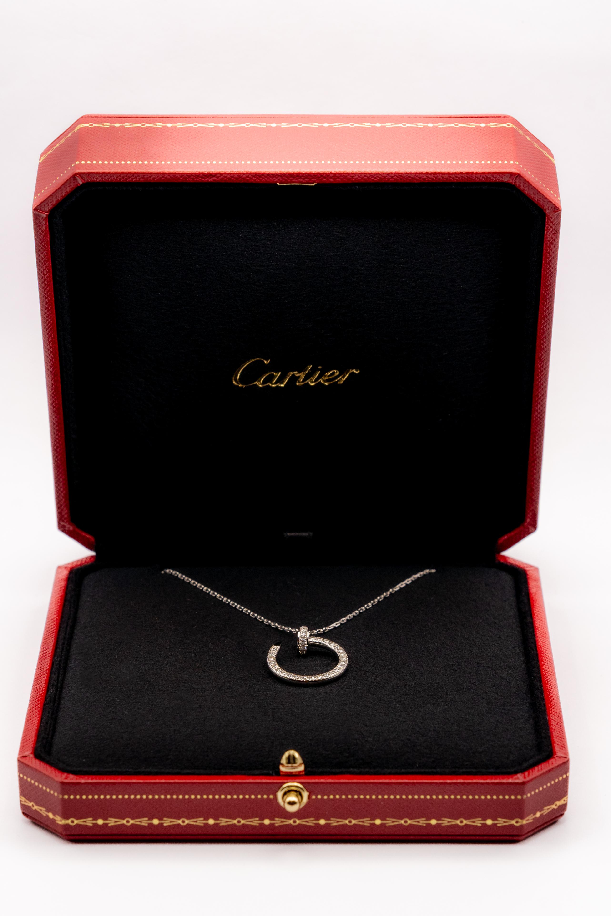Authentic Cartier Juste un Clou pendant crafted in 18 karat withe gold on an oval-link chain. The pendant is set with approx. 0.38 carats of round brilliant cut diamonds (E-F color, VS clarity) and is situated on 40,5 cm  adjustable chain. Signed