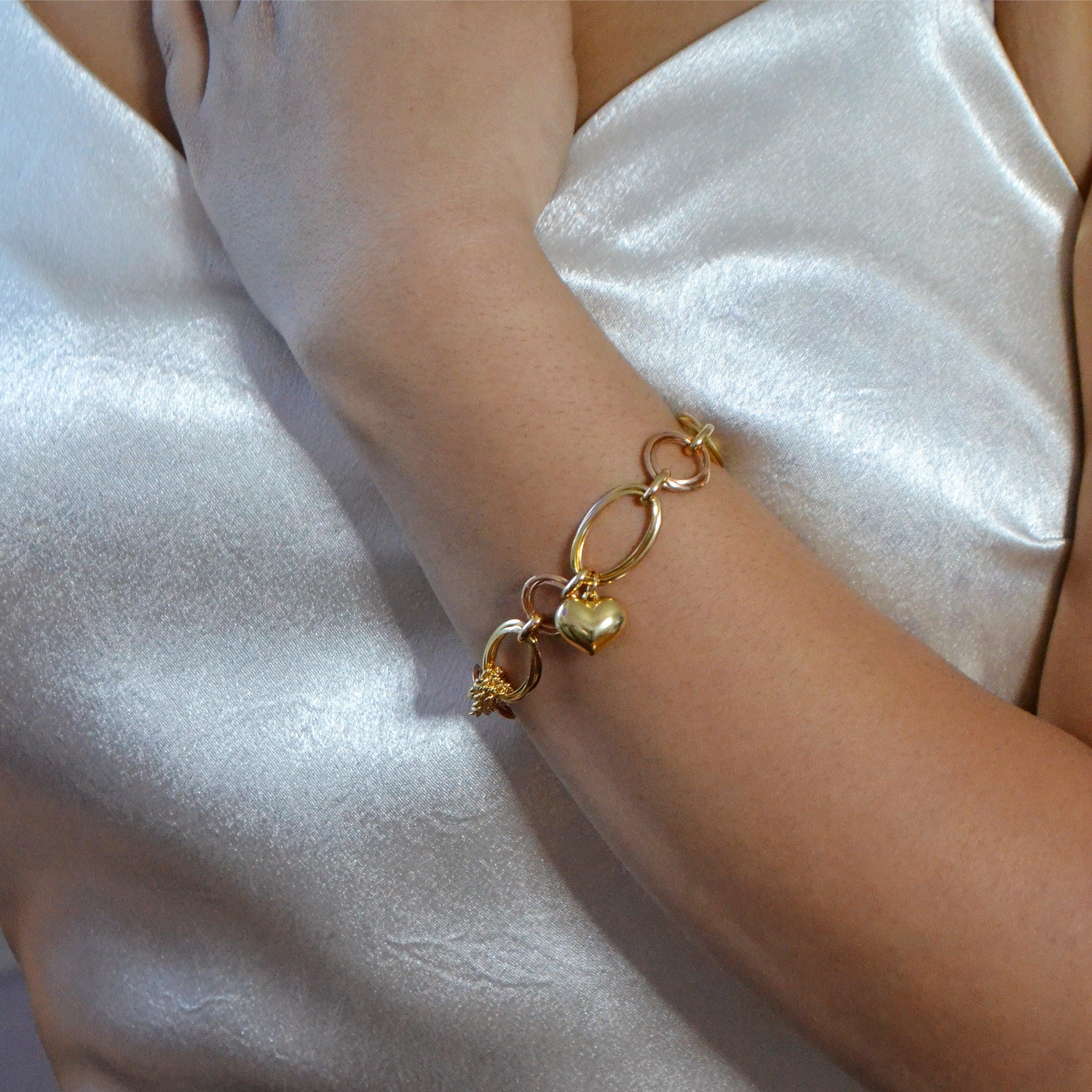 This stunning handcrafted bracelet showcases an intricate dual-chain design, combining 18-karat yellow and rose gold for a striking contrast. Measuring 7.75 inches (19.7 cm) in length, it features a mix of bold, open-link chains and delicate mesh