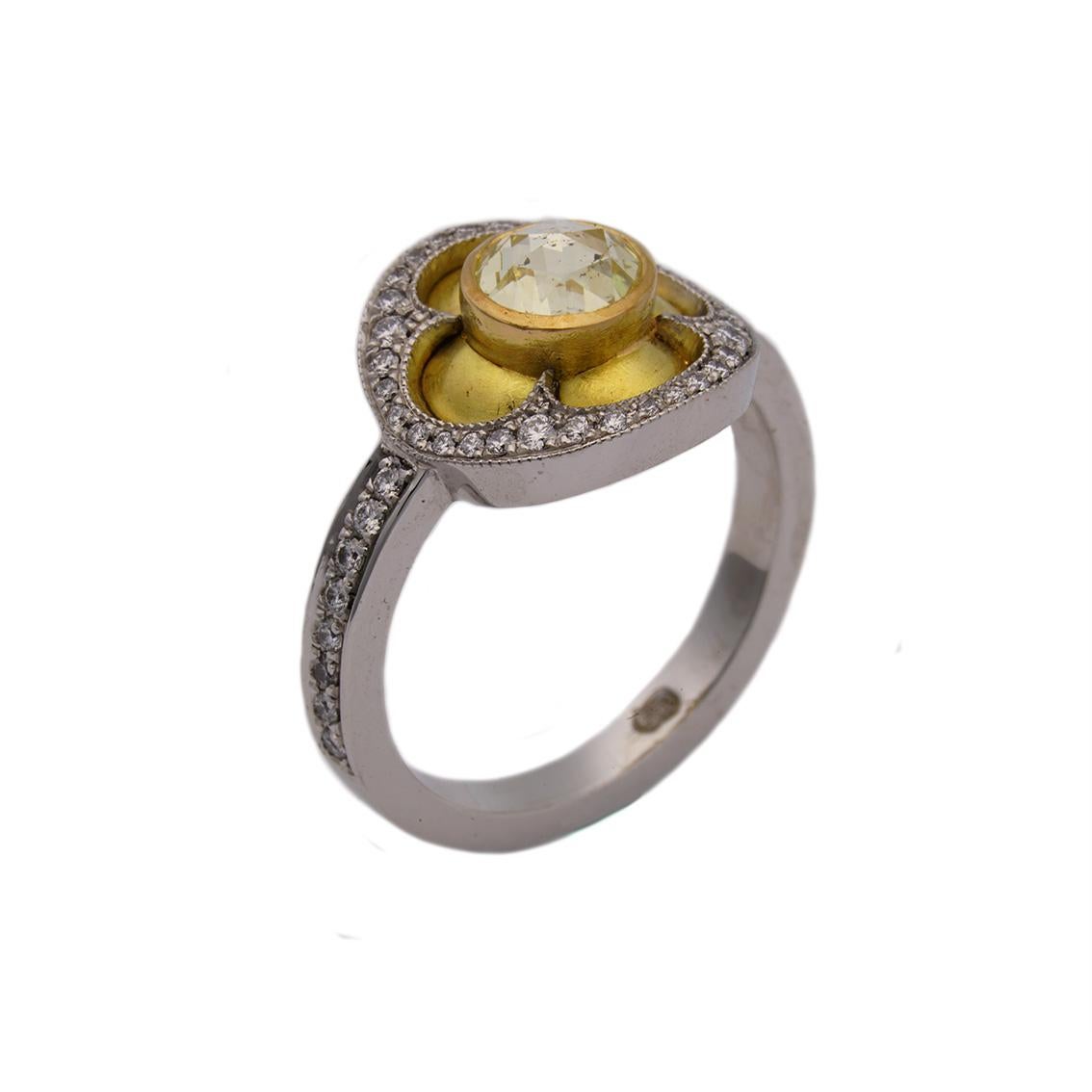 This 18kt gold ring is utter indulgence. 

Handmade from 18kt yellow and white gold this glorious ring has been inspired by the quatrefoil, a symbol used throughout Gothic architecture. 

This stunning ring features a central, bezel set, rose cut,