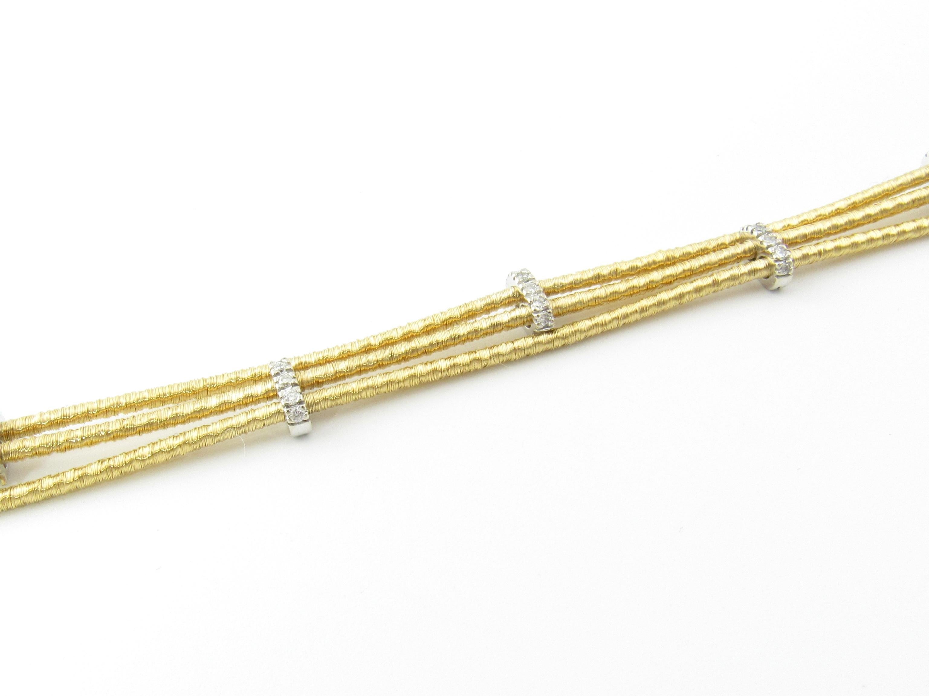 Vintage 18 Karat Yellow and White Gold and Diamond Bracelet

This lovely triple cable bracelet is decorated 30 round brilliant cut diamonds set in beautifully detailed 18K white gold. Cables are 18K Yellow Gold Width: 9 mm. Safety