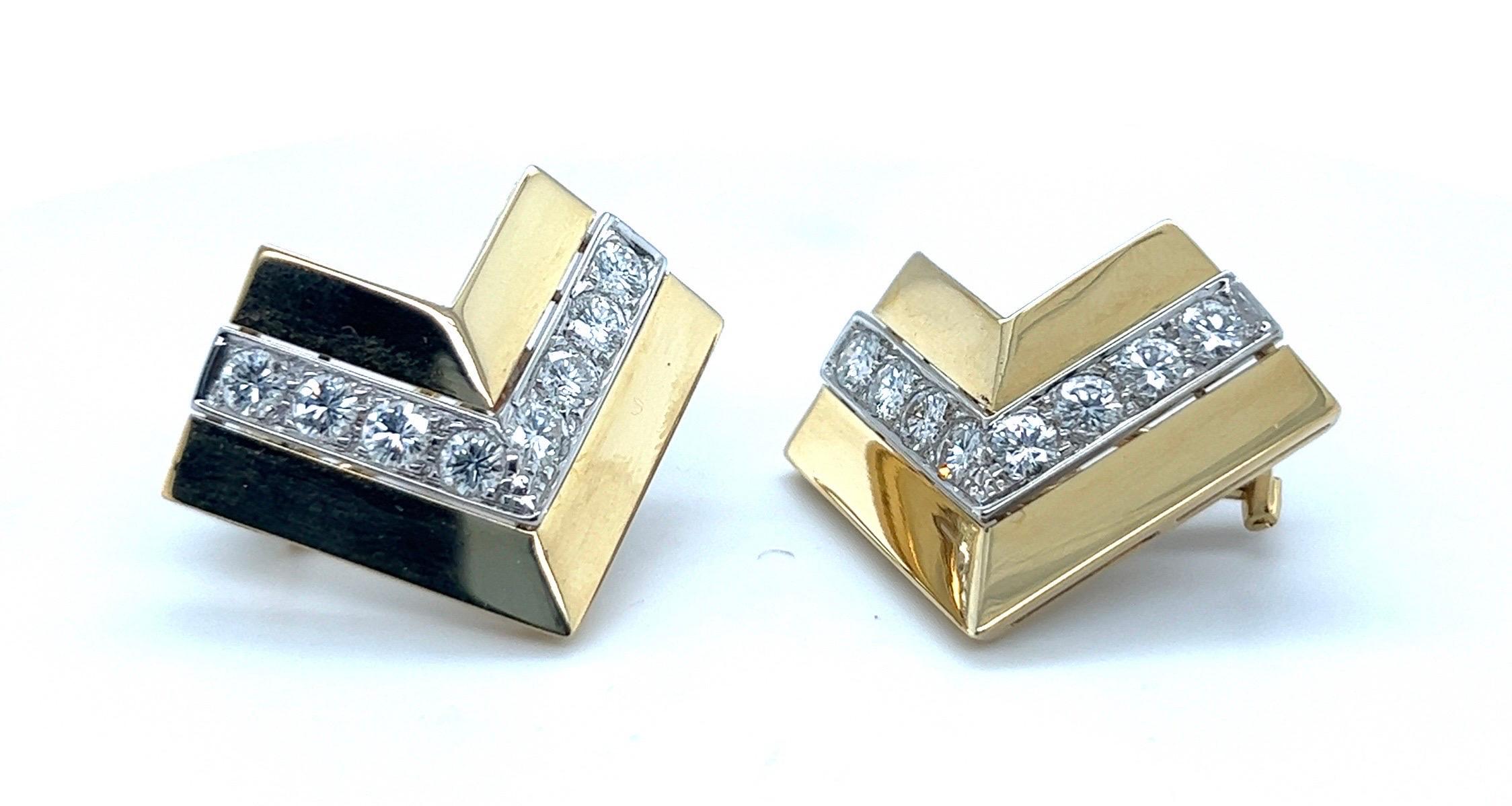 Attractive pair of 18 karat yellow and white gold and diamond ear clips. 

Eye-catching, v-shaped ear clips, the center line set with 8 brilliant-cut diamonds totalling circa 2.5 carats, flanked by two polished gold borders. The earrings are
