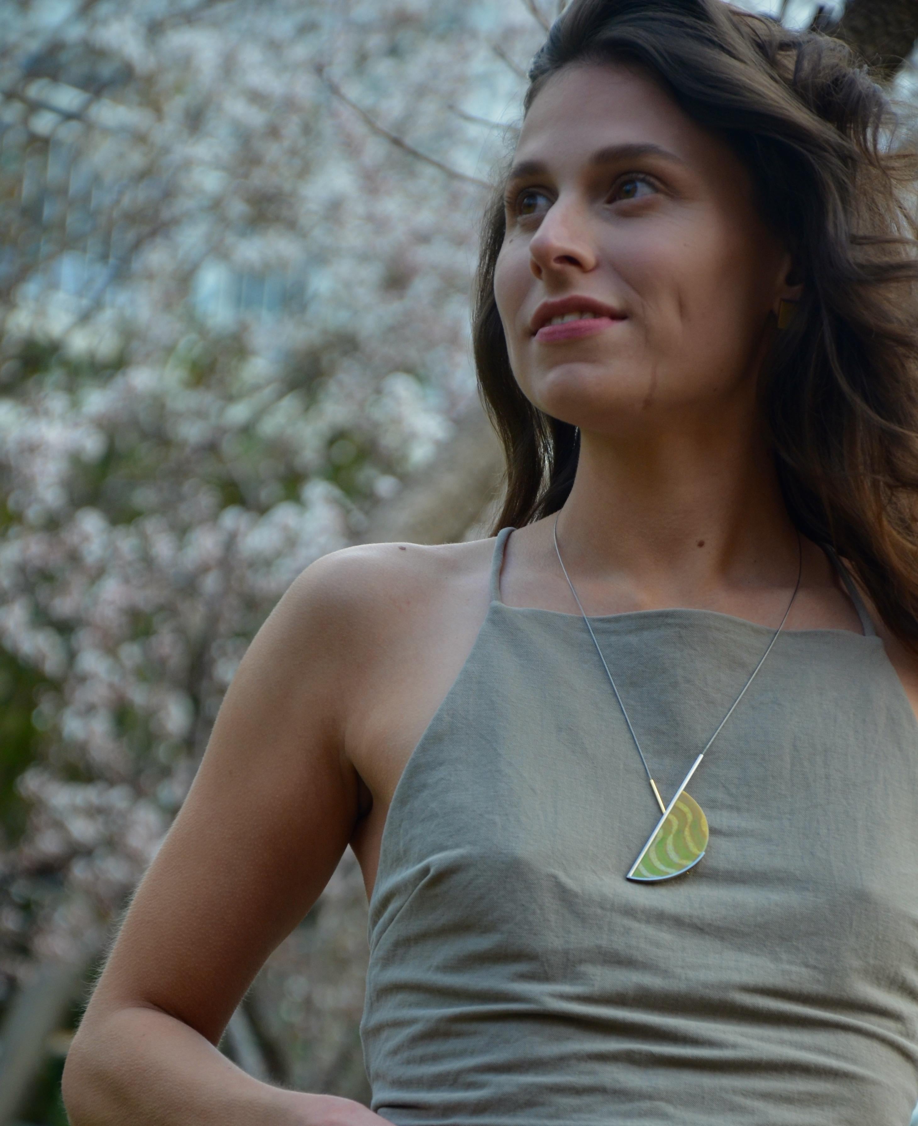 18 karat Yellow and White Gold Art Nouveau Glass Necklace.

A long necklace with a unique piece of Art Nouveau Glass in yellow/orange/gold/green, 18 karat yellow and white gold, and stainless steel, designed by Arno Schneider. Depicting his favour