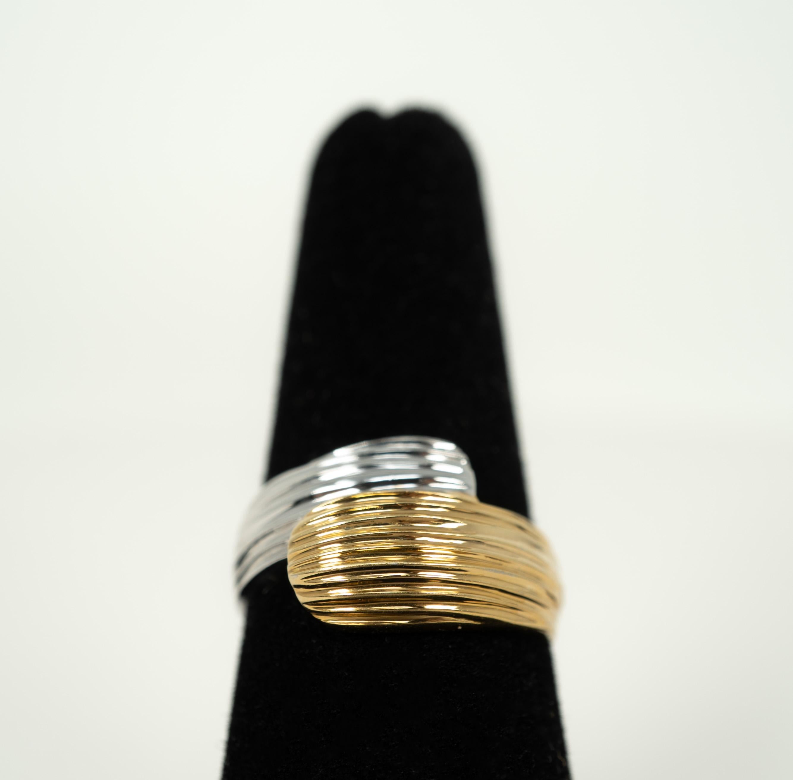 In fluted 18 karat yellow and white gold, this fun bypass ring is a great addition to any collection!