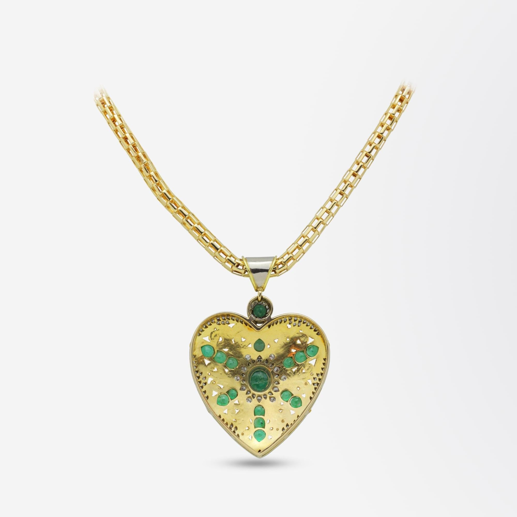 A bold two tone gold necklace with a large emerald and diamond heart pendant. This unusual pendant is handcrafted with textured acanthus type scrolls. The piece centres on a cabochon emerald that is surrounded by a double 'star' halo that has been