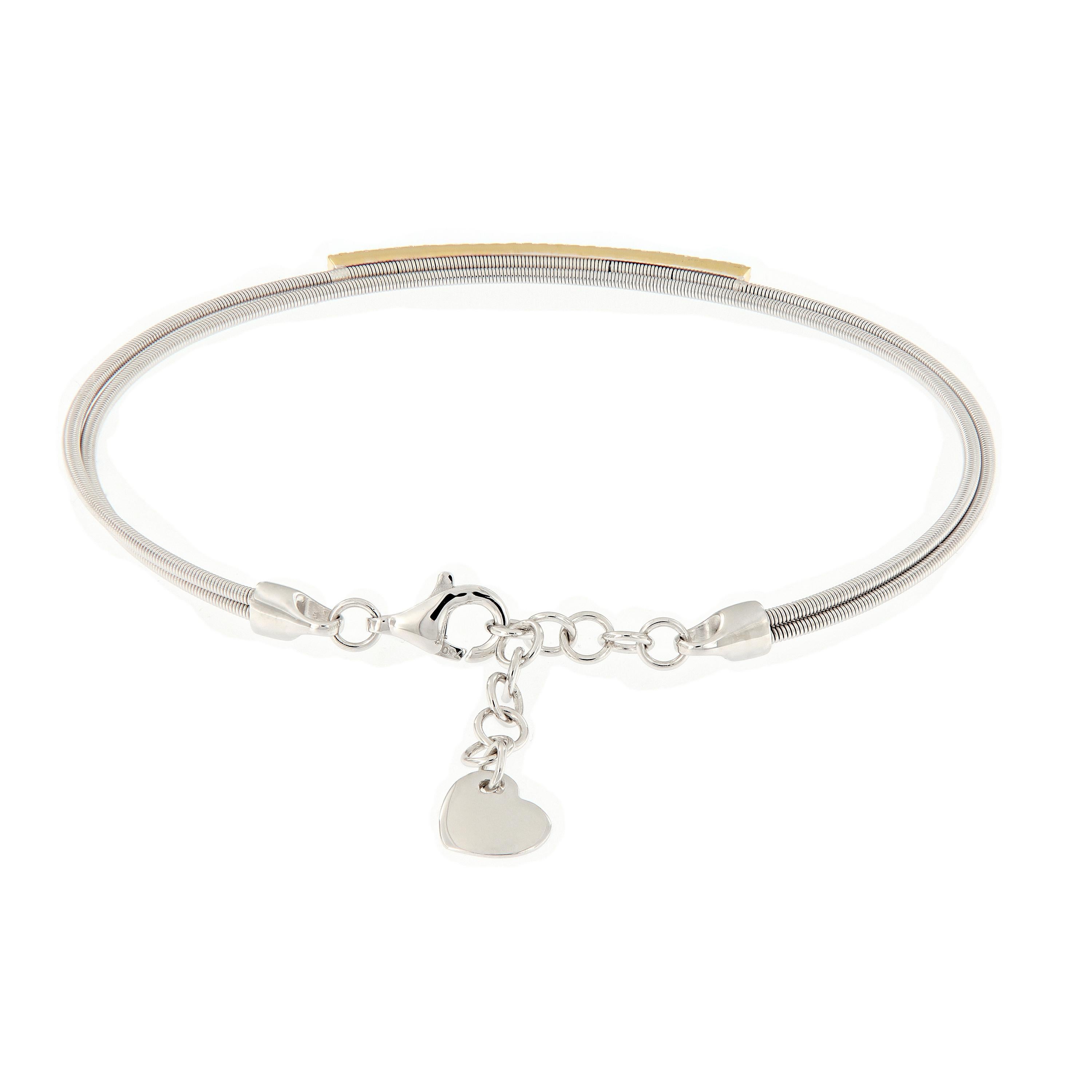 Wrap her wrist in the sparkle and comfort. This double wire bracelet is crafted in 18k white gold accented with a 18k yellow bar of diamonds. Bracelet secures with a safety chain clasp detailed with a heart dangle. Weighs 5.5 grams. Measures 2.25