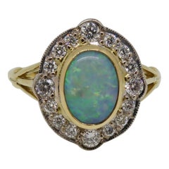18 Karat Yellow and White Gold Oval Opal and Diamond Art Deco Style Cluster Ring